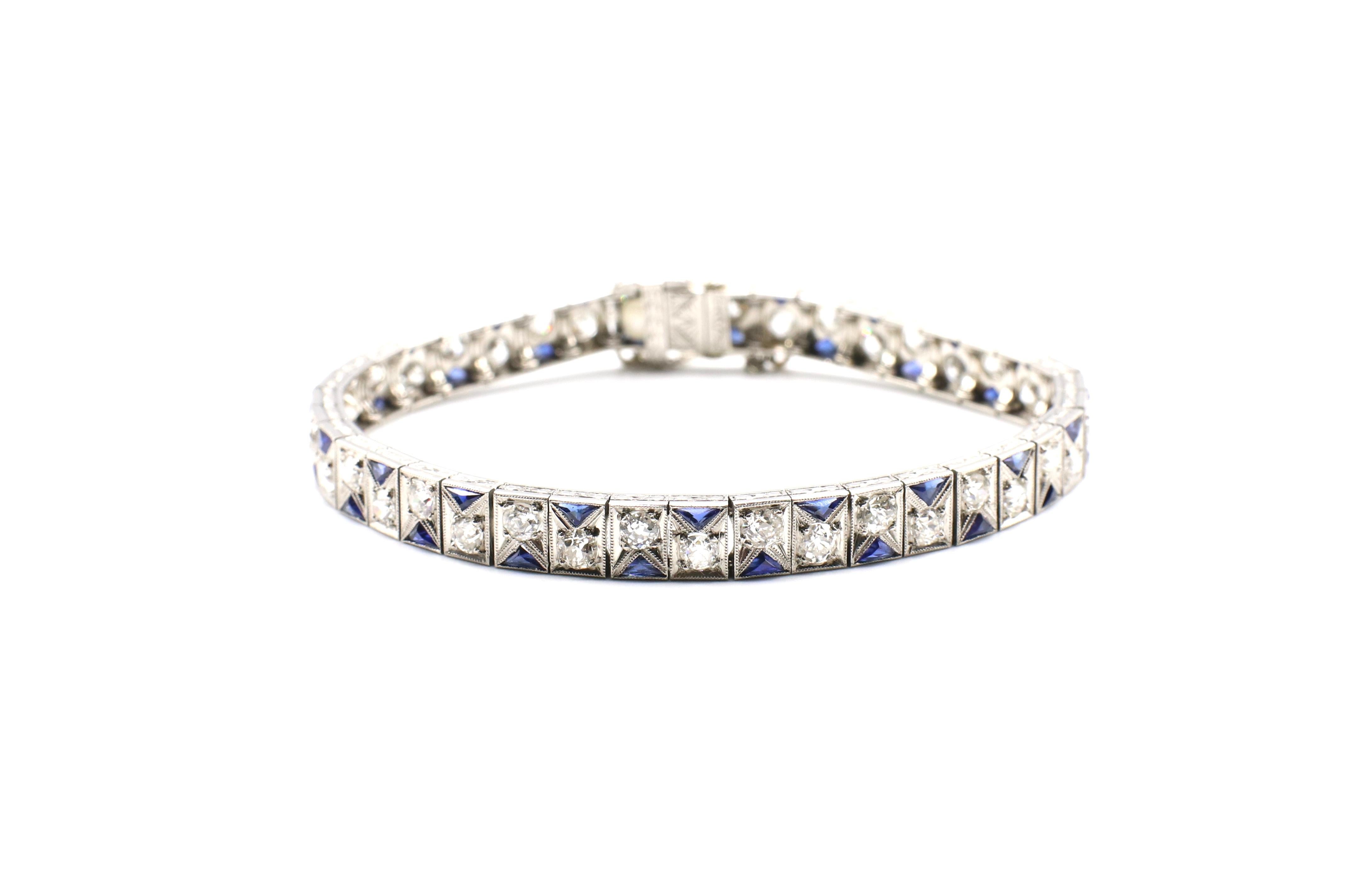 Art Deco platinum diamond & sapphire bracelet with approximately 3.5 carats of Old European cut and mine cut diamonds, G-H SI-I1,  delicate etching design on the sides and clasp. A safety chain connects the bracelet for security. The bracelet is