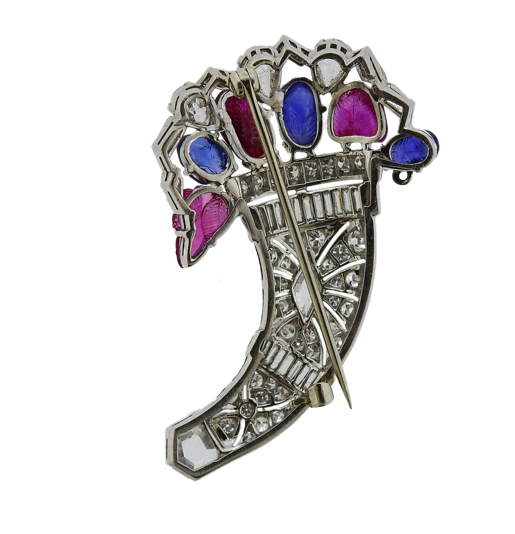 Platinum tutti frutti basket brooch pin, set with carved rubies and sapphires, surrounded with a total of approx. 3.60ctw in diamonds. Brooch is 46mm x 28mm. Weight is 12.2 grams. Marked: Plat.