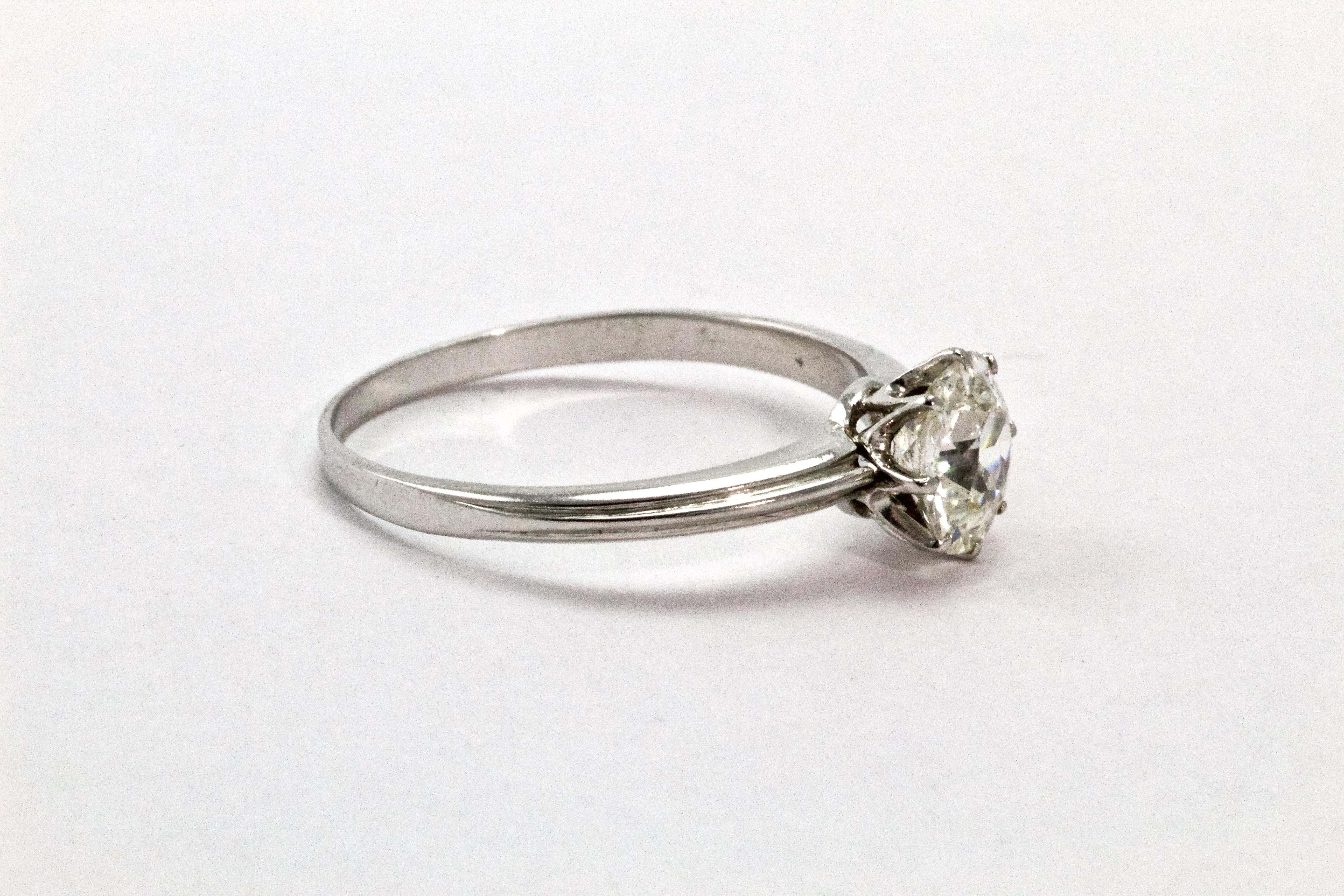 This classic and stunning diamond solitaire ring dates back to the 1920s, and is expertly made. The stone is 1.02 carats. The Old European cut diamond (H - VS2) is beautifully claw set within a wonderfully hand made collet, which features a simple