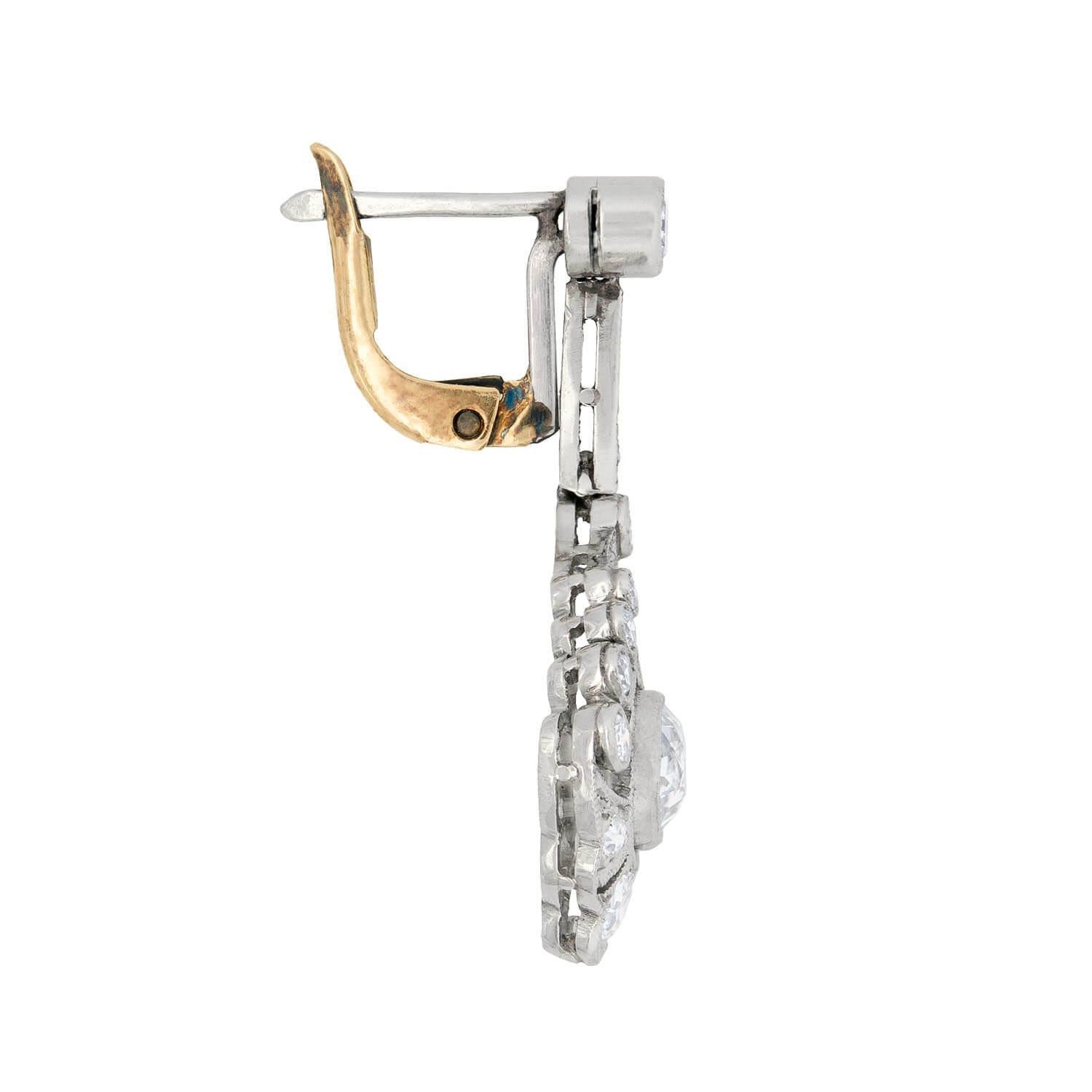 Exquisite hanging diamond earrings from the Art Deco (ca1920) era! These incredible teardrop-shaped earrings are made of platinum and are encrusted with approximately 3ctw of beautiful old Mine Cut diamonds. The stones range in color from H-I and