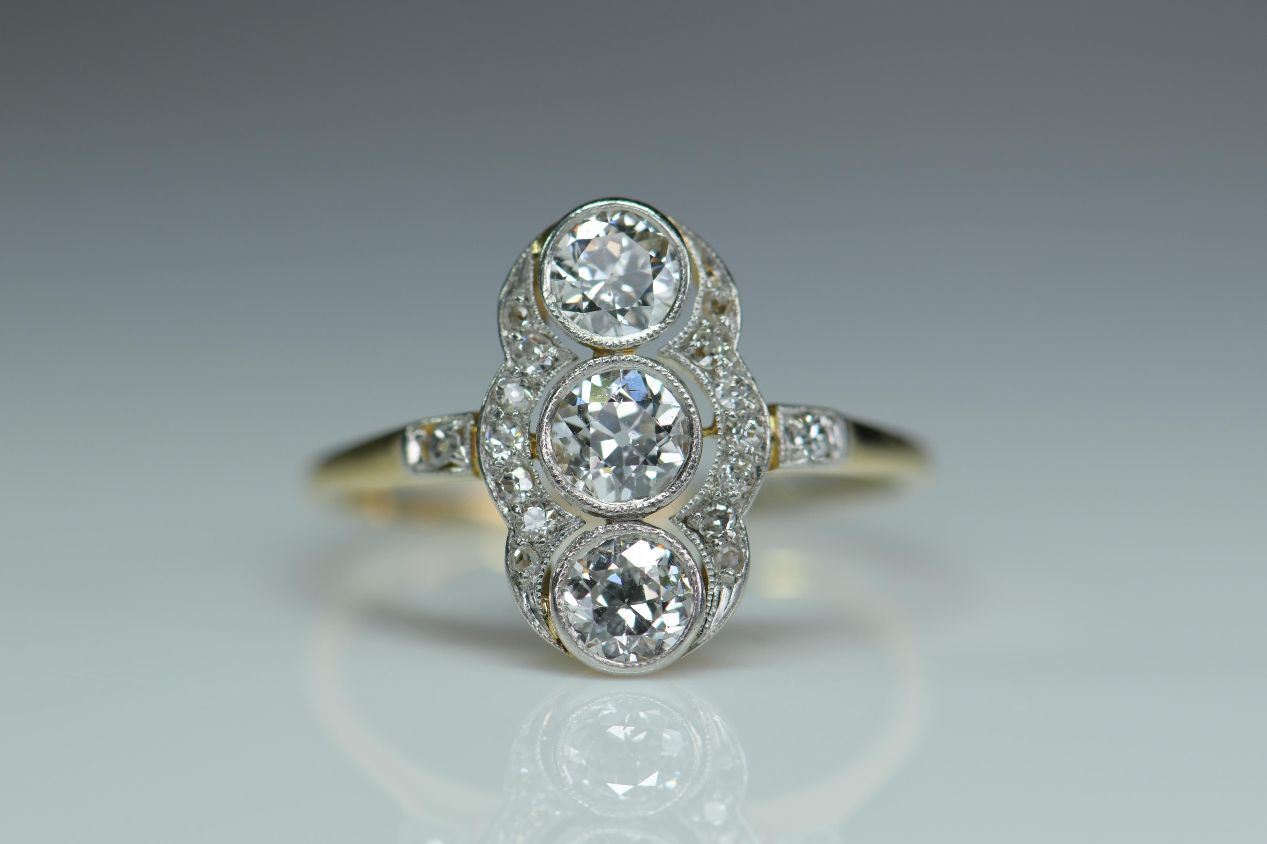 A wonderful platinum ring that is typical of the Art Deco period with it’s striking design. It is a pleasing oval shape that is very flattering to the finger when worn. Down the center are set three well matched white diamonds in open settings.