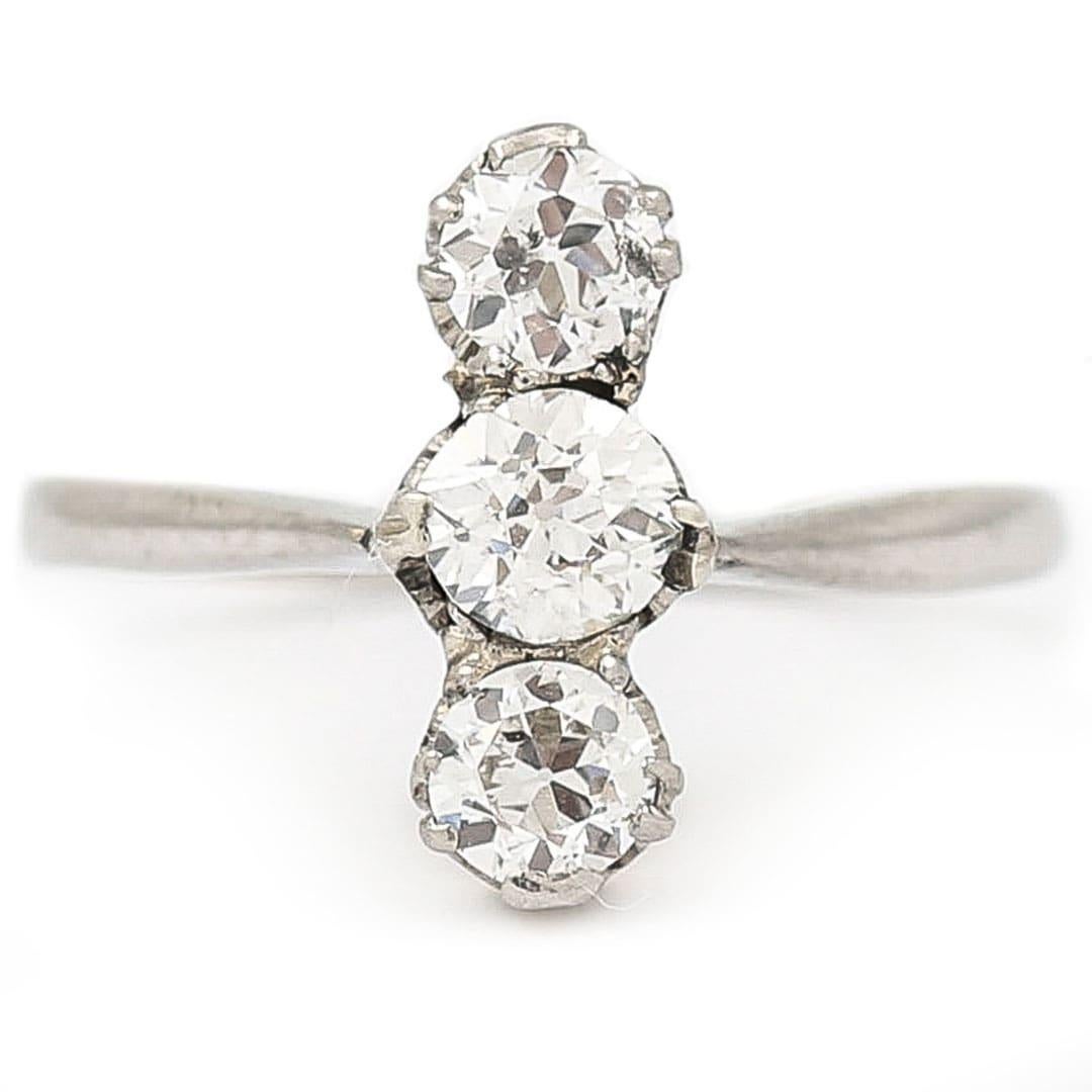 A beautiful and timeless Art Deco platinum diamond three stone ring set with two round brilliant cut diamonds and one central Old Mine cut stone with a total weight of 0.50ct approx. With lovely bright diamonds that scintillate very well this