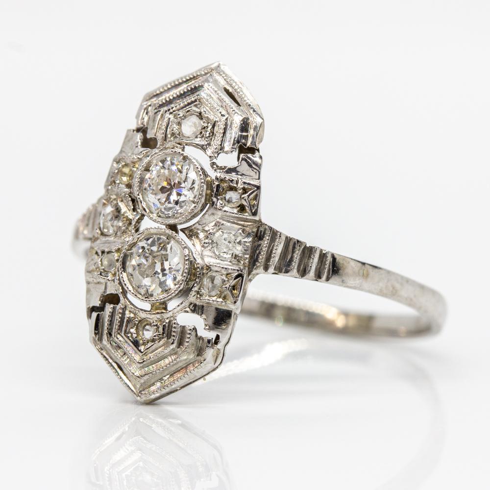 Period: Art Deco (1920-1935)
Composition: Platinum
•	2 old mine cut diamonds of H-SI1 quality that weighs 0.40ctw (0.20ctw each.)
•	8 rose cut mine cut diamonds of I-SI1 quality that weigh 0.10ctw
Ring size: 8 ½ 
Ring face measure: 19mm by 9mm
Rise