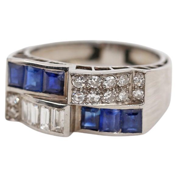 Art-Deco Ring Made of Platinum Integrated with Diamonds & Sapphires of different cut shapes. The emerald and rectangular Sapphires, round-cut Diamonds & Baguette-cut Diamonds.
A magnificent example of the Art-Deco era (apparently from the 1920s) in