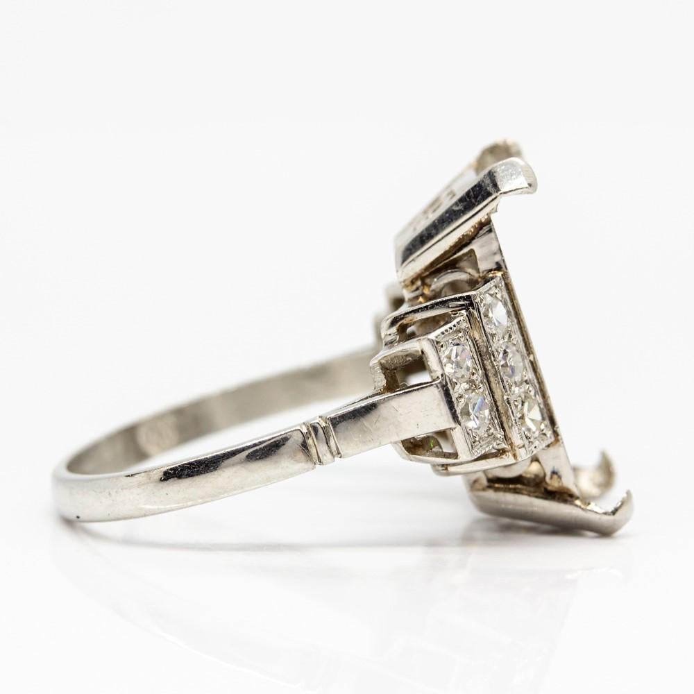 Period: Art Deco (1920-1935)
Composition: Platinum
•	10 single cut diamonds of H-VS2 quality that weighs 0.30ctw.
Center measure:  15mm by 9mm
Ring size: 7
Ring face measure: 19mm by 17mm
Rise above finger: 7mm
Total weight: 5.3 grams – 3.4dwt
