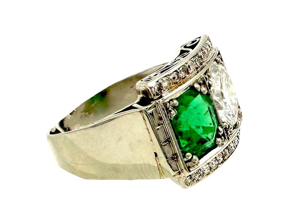 This substantial Art Deco ring was created in 1925 ca. It is handcrafted out of platinum, a so called pinkie ring. The ring is set with a diamond and an emerald.  The emerald has an established weight of 1.2 carats, the diamond weighs 1.5 carats.