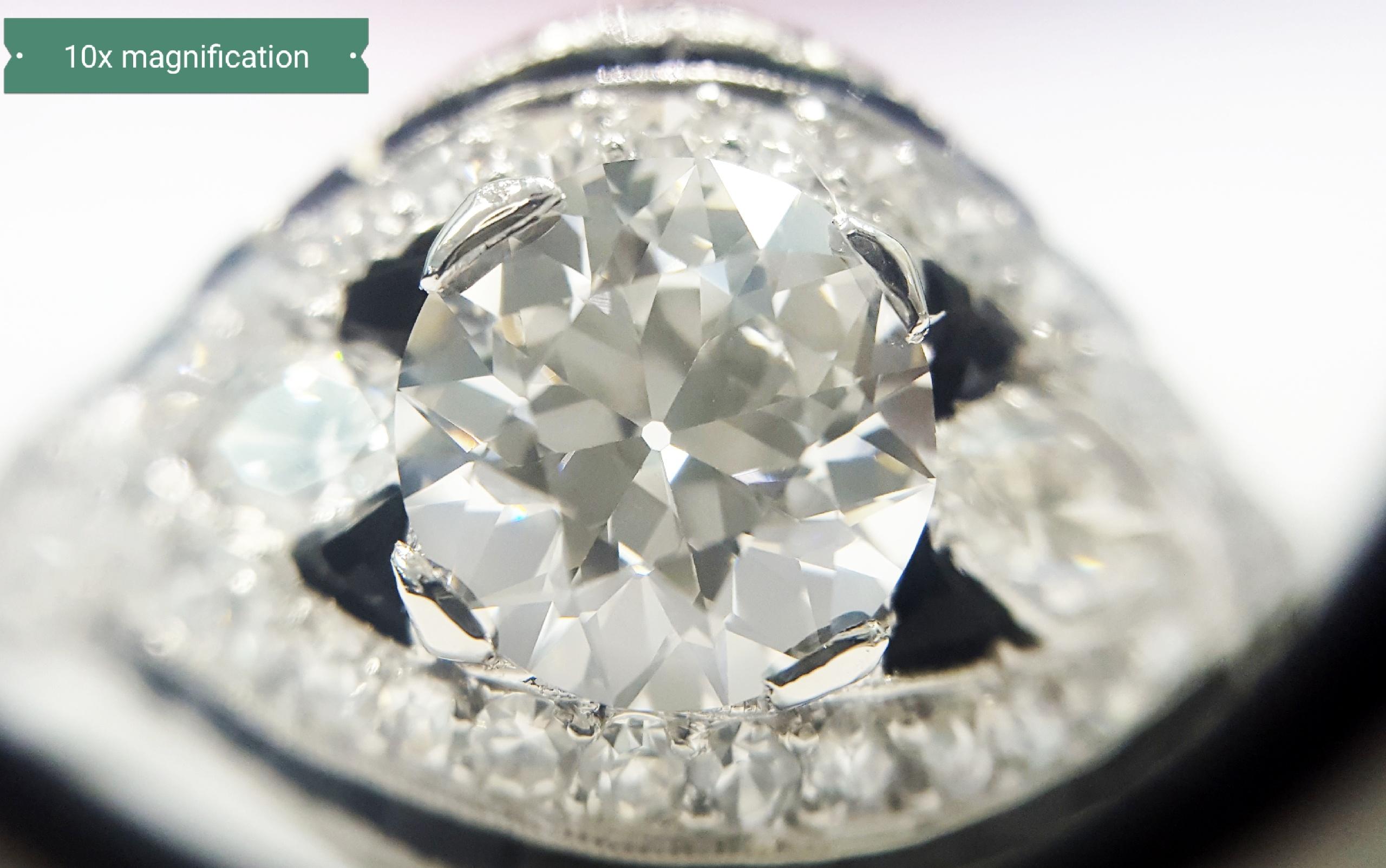 A unique and beautiful ring from the 1930's. Crafted in platinum, the center diamond is a, GIA Certified, 1.61ct D color, VS1 clarity, Circular Brilliant Cut. In addition to the center diamond, there are 2 Marquise cut diamonds that weigh 0.25cttw 