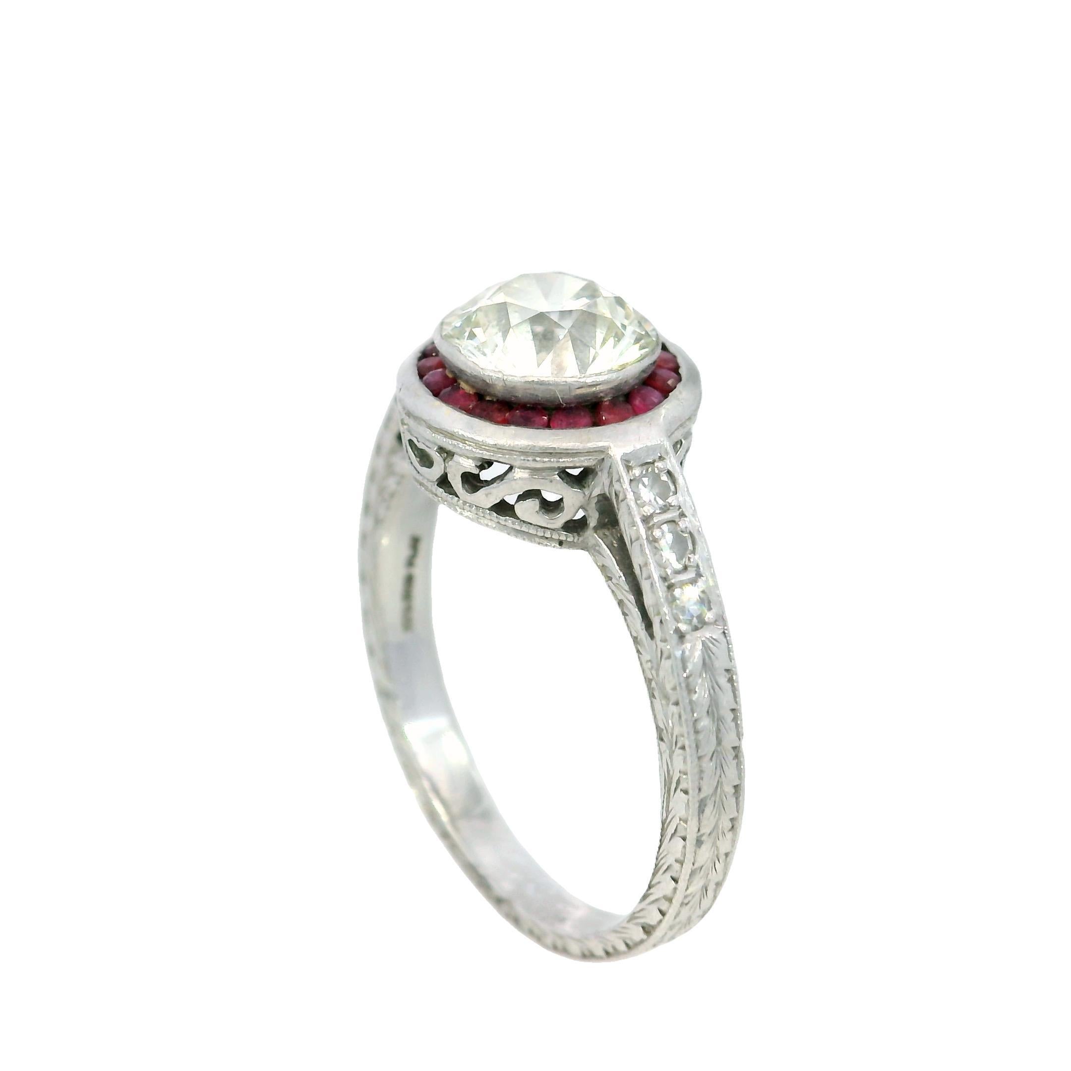 Art Deco Platinum Engagement Ring with Rubies and ~1.62ct Transitional Cut Diamond

This elegant Art Deco ring is a masterful blend of sophistication and intricate detail, crafted in the early 20th century. At its center lies a 1.62-carat