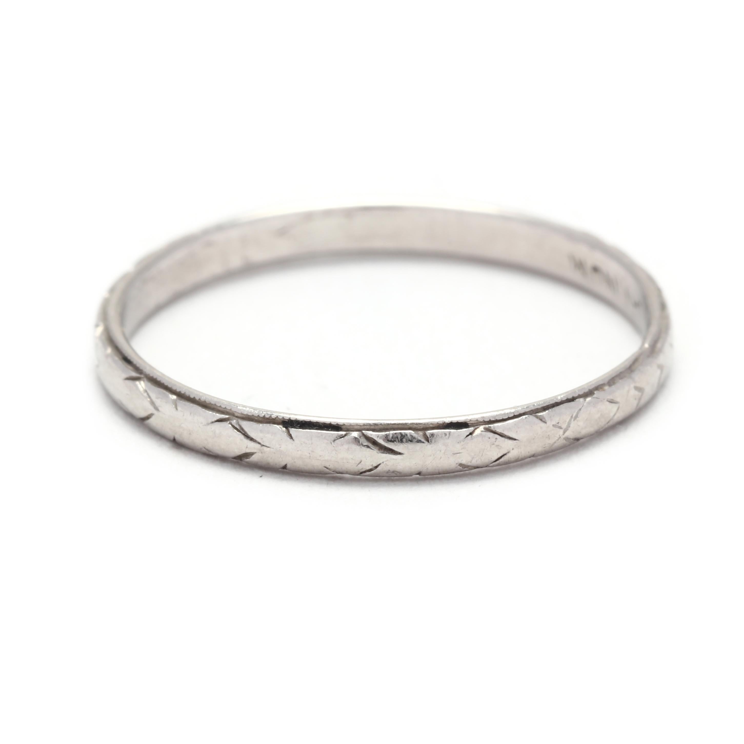 This Art Deco Platinum Engraved Wedding Band is a stunning and unique choice for a wedding or anniversary ring. Made with platinum, this ring features delicate and intricate engravings, creating a beautiful texture and design. The band is thin and
