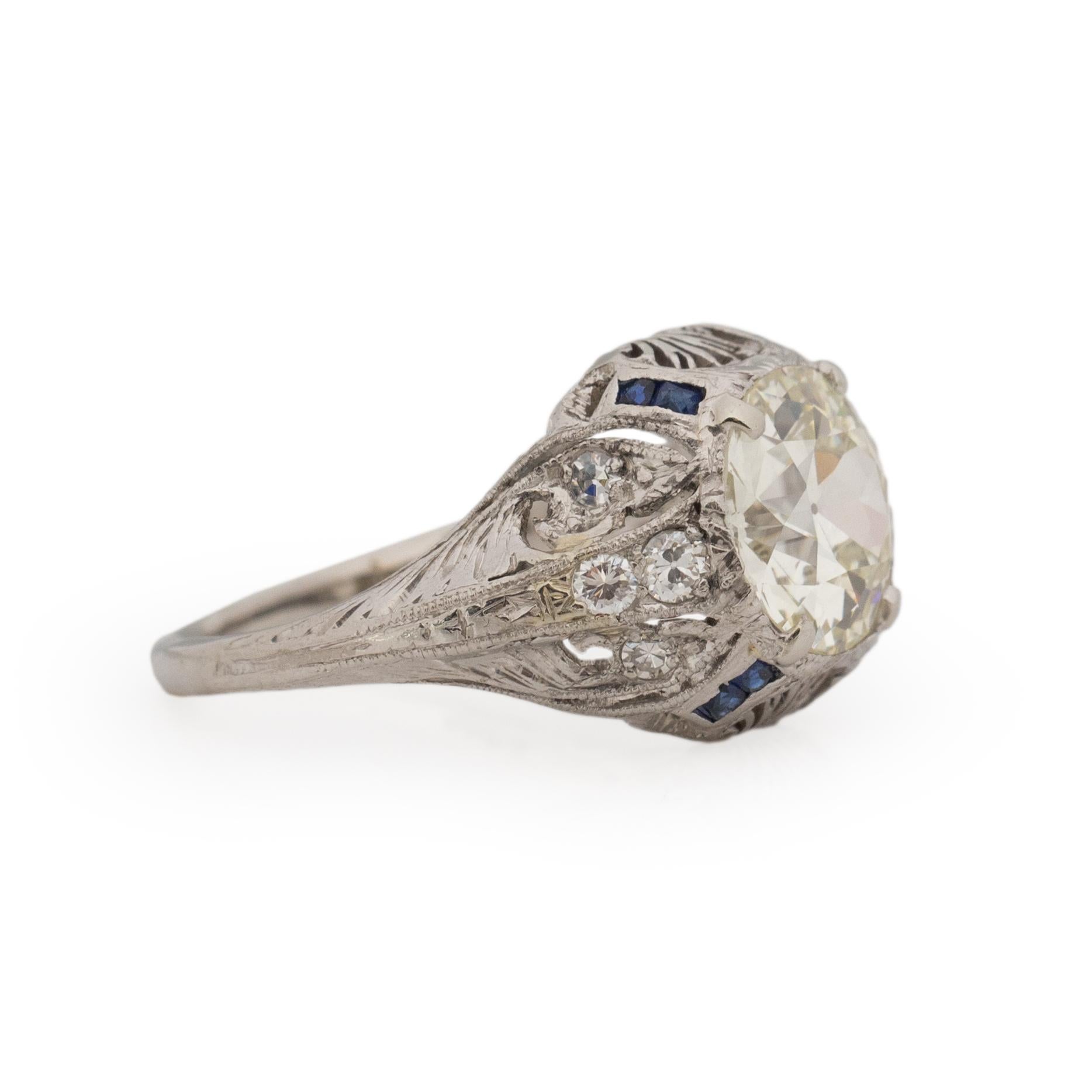 This Art Deco piece is right in between the Art Deco and Edwardian Era. Crafted in platinum the shanks support effortless organic engraving accompanied by filigree open work. Along the cathedral shanks are diamond accents that add just the right