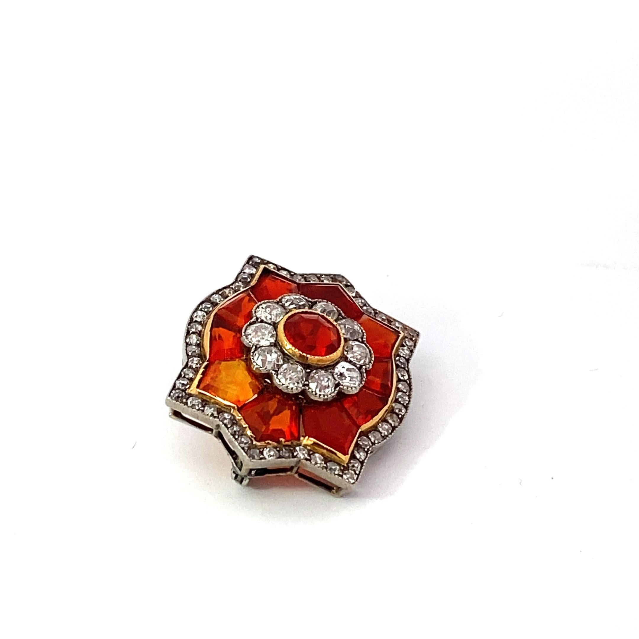 One of the most gorgeous pieces of jewelry I've seen in quite some time. A fiery and amazing brooch crafted in platinum with the most amazing calibrated fire opals we've seen. Adding to all of that are two diamond surrounds giving the brooch the