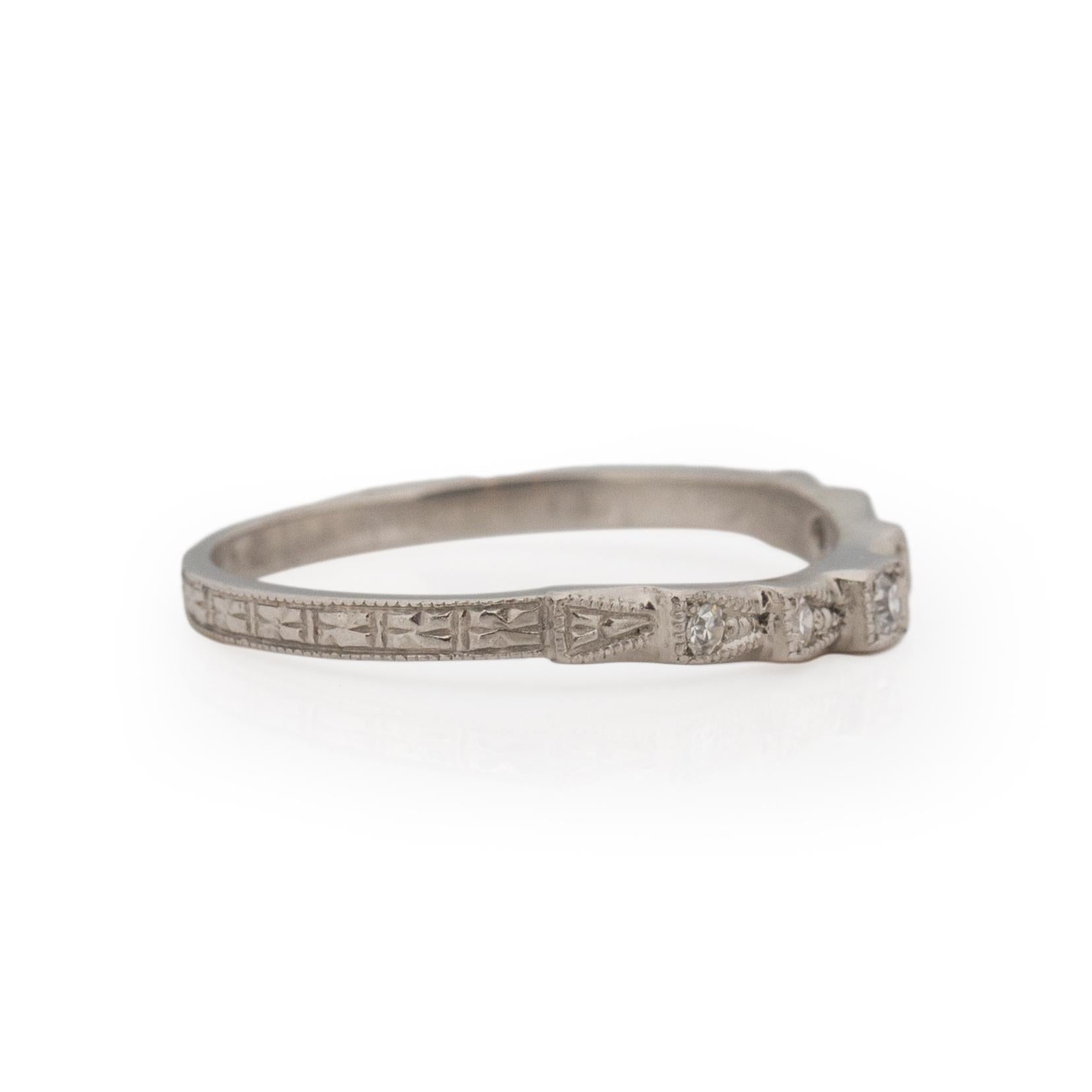 This exquisite art deco band has an outstanding design! Crafted in platinum, the shanks support a beautifully carved floral like pattern, this pattern leads you to a delicate step shape, nestled into the steps are single cut diamonds that give this