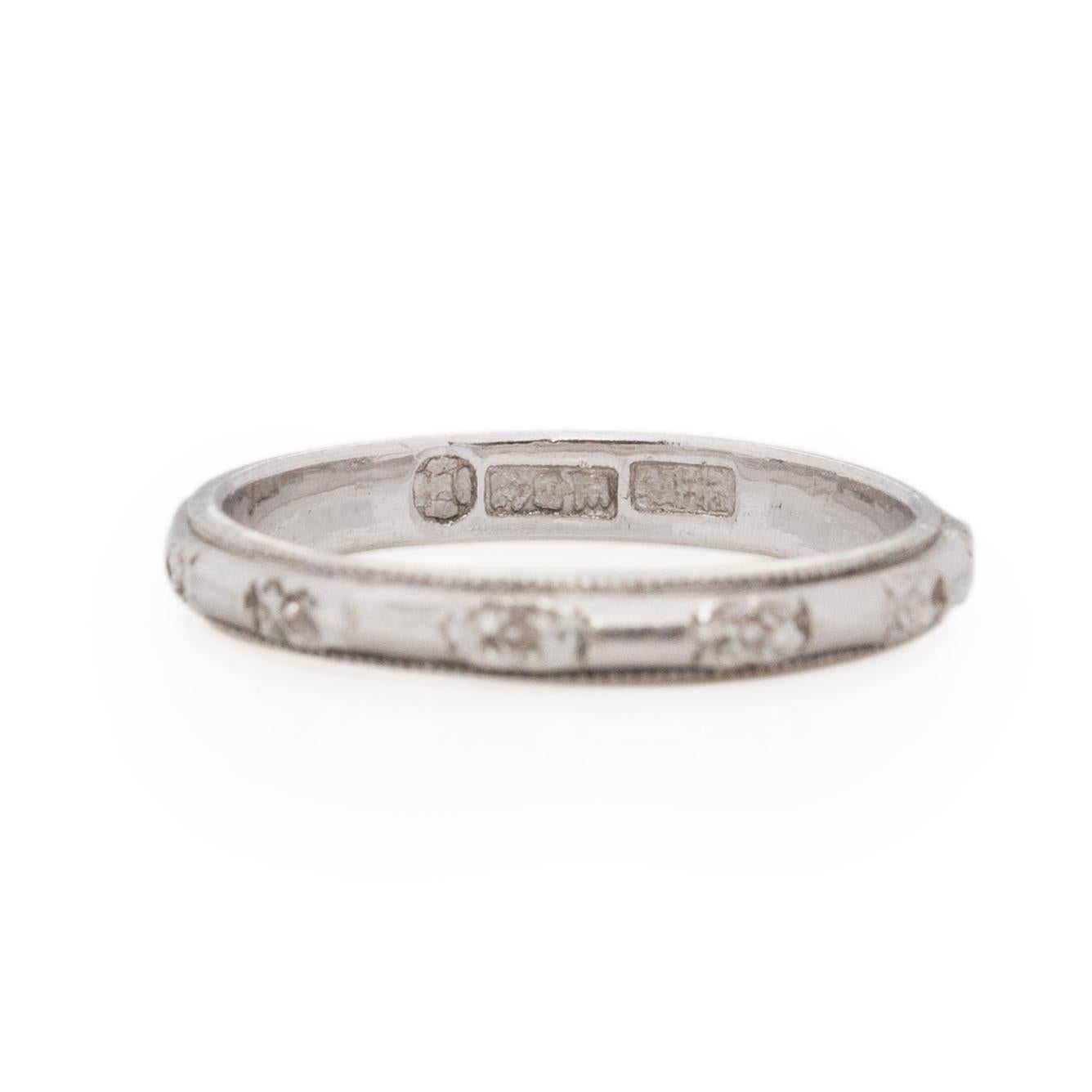 Here we have a very well made, hand carved band that is in excellent condition for its age. This ring has a beautiful floral repeating pattern that is accompanied by a milgrain border on either side. The carving is deep and clean, giving this ring a