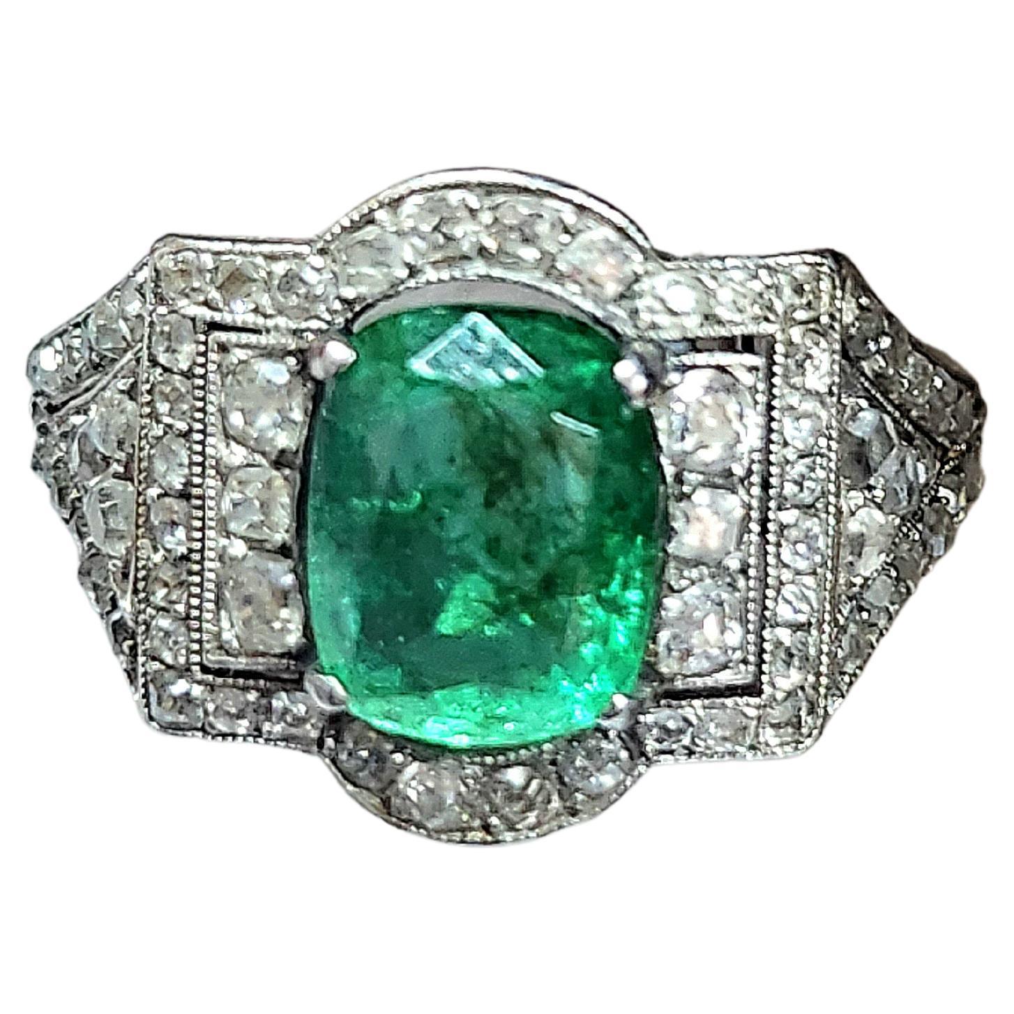 Art deco platinum ring centered with 1 natural rich green emerald colour in oval cut with a stone diameter of 8.45mm×7mm estimate weight 3 carats flanked with rose cut diamonds ring was made in france during the art deco era 1930.c hall marked with