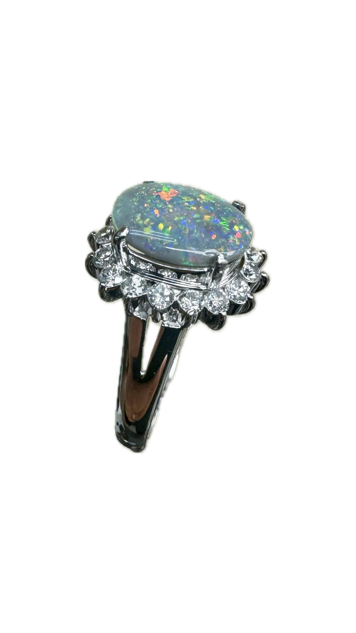 DeKara Designs Collection

Metal- 90% Platinum, 10% Iridium.  

Stones- Genuine Australian Black Opal 1.29 Carats, 16 Round Diamonds F-G Color VS2 Clarity 0.54 Carats.

Size- 6 3/4.  FREE SIZING!!!!

Handmade Platinum and Diamond Engagement Ring