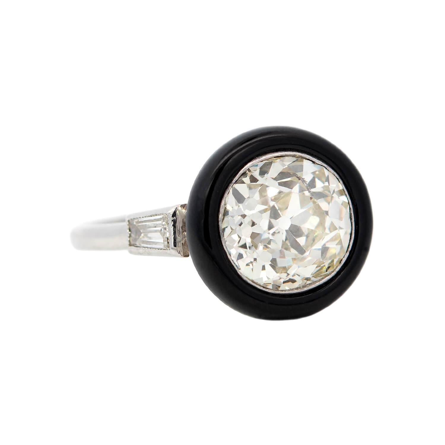 A striking ring from the Art Deco (ca1930s) era! Crafted in platinum, this ring adorns an old Mine Cut diamond within a bezel setting. The diamond, weighing approximately 2.46ct in L/M color and SI2 clarity, is set in a deep black onyx halo,