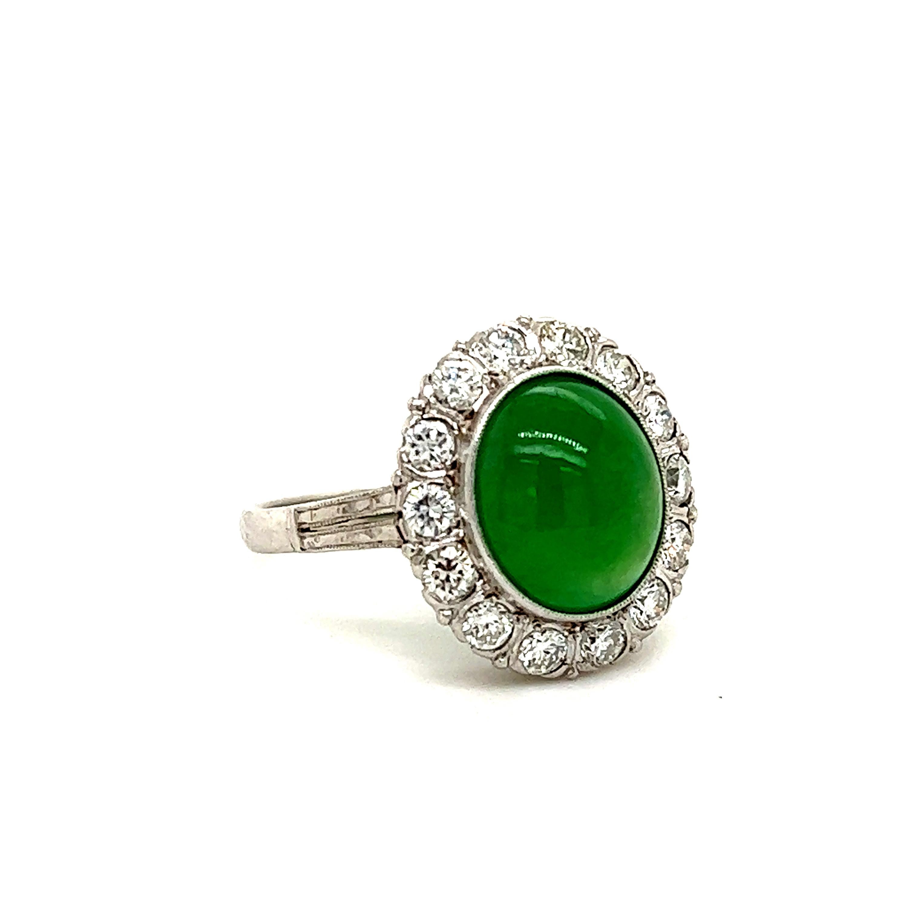 Fantastic design seen on this art deco treasure! This gorgeous ring is crafted in platinum and showcases one cabochon cut jade gemstone. The gemstone displays a vibrant green color that pops off the platinum design. The jade gemstone is bezel set in