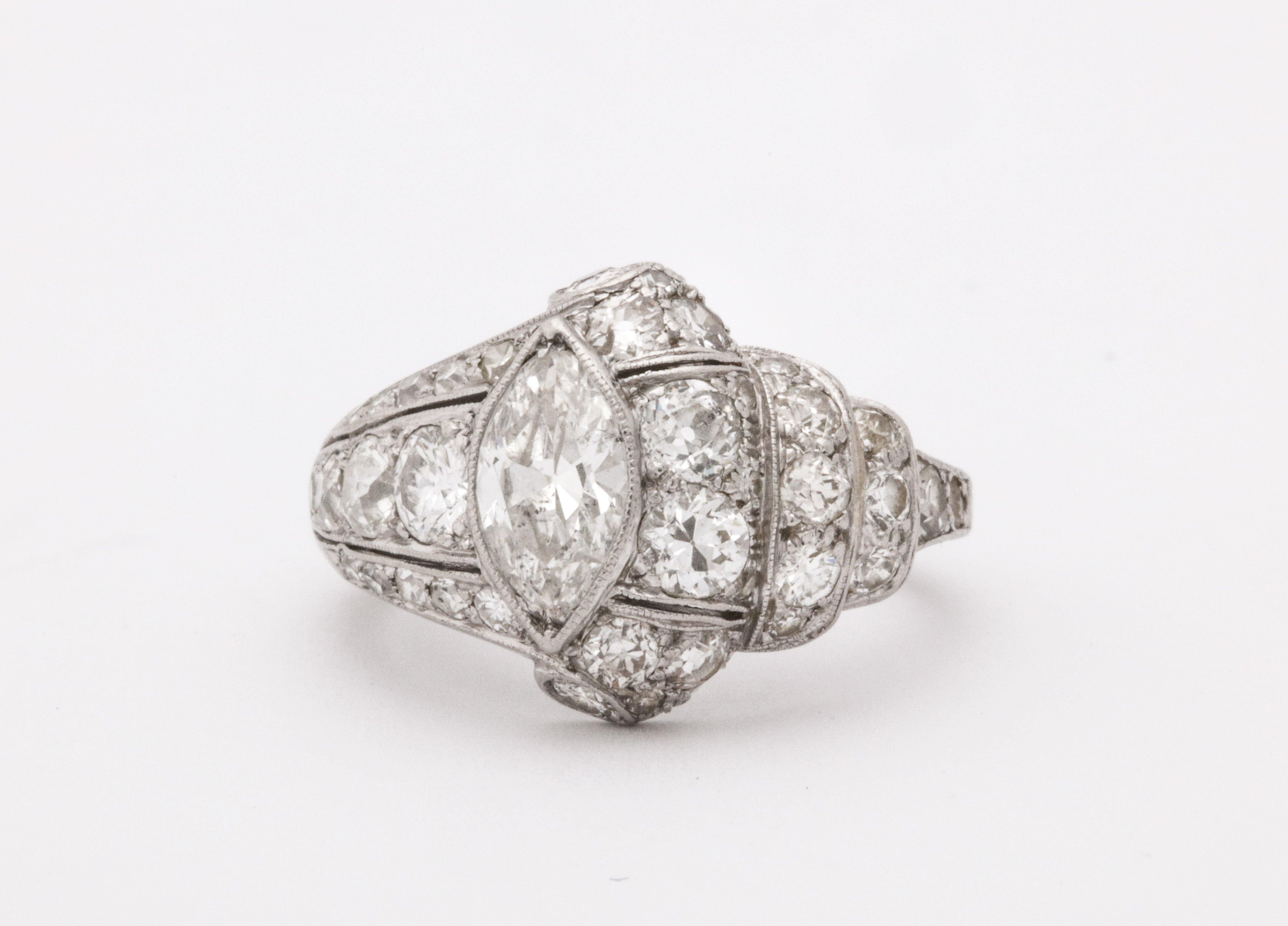 A wonderful Art Deco platinum engagement/cocktail ring with a center marquise 0.80 carat diamond surrounded with 0.80 carat of smaller diamonds.