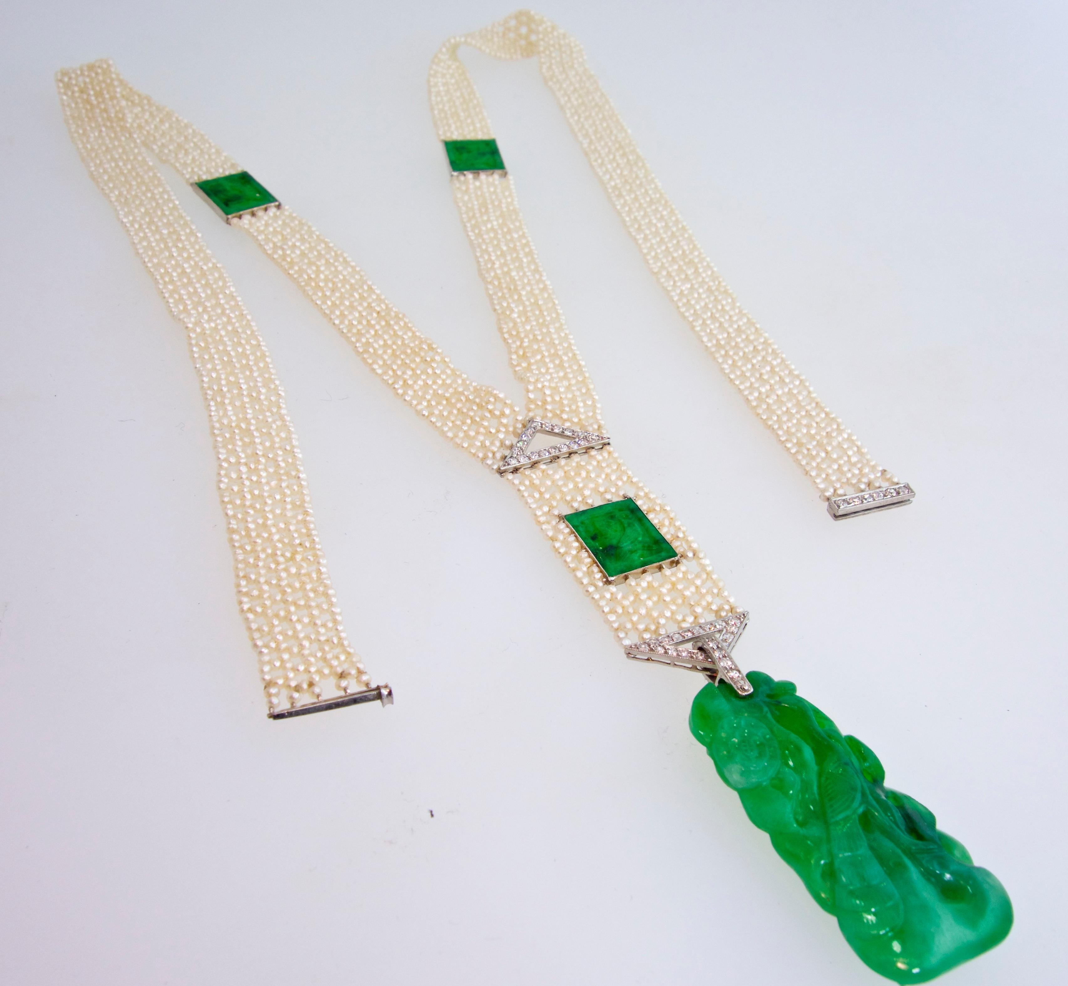 The natural pearls are woven and decorated with two plaques of fine carved natural untreated jadeite jade. Suspended at the bottom is a matching jadeite jade and diamond pendant.  The natural untreated carved jade is brilliant bright green jade. 