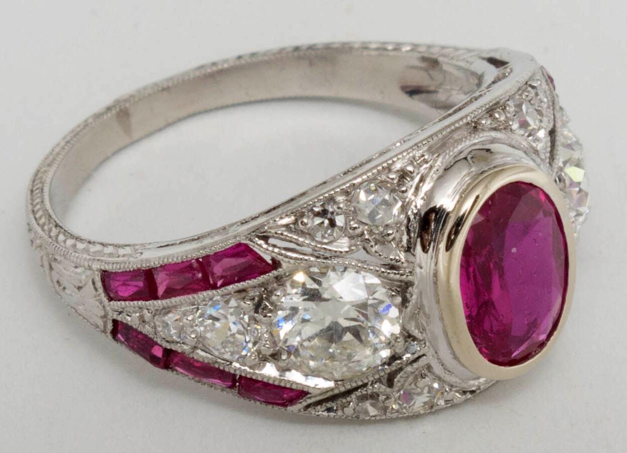 A beautiful platinum Art Deco period natural ruby and diamond ring with wonderful milgrain work. 

An oval-shaped natural ruby, approximately 0.70 carat surrounded by old European- and single-cut diamonds, total approximately 0.70 carat. 
Total