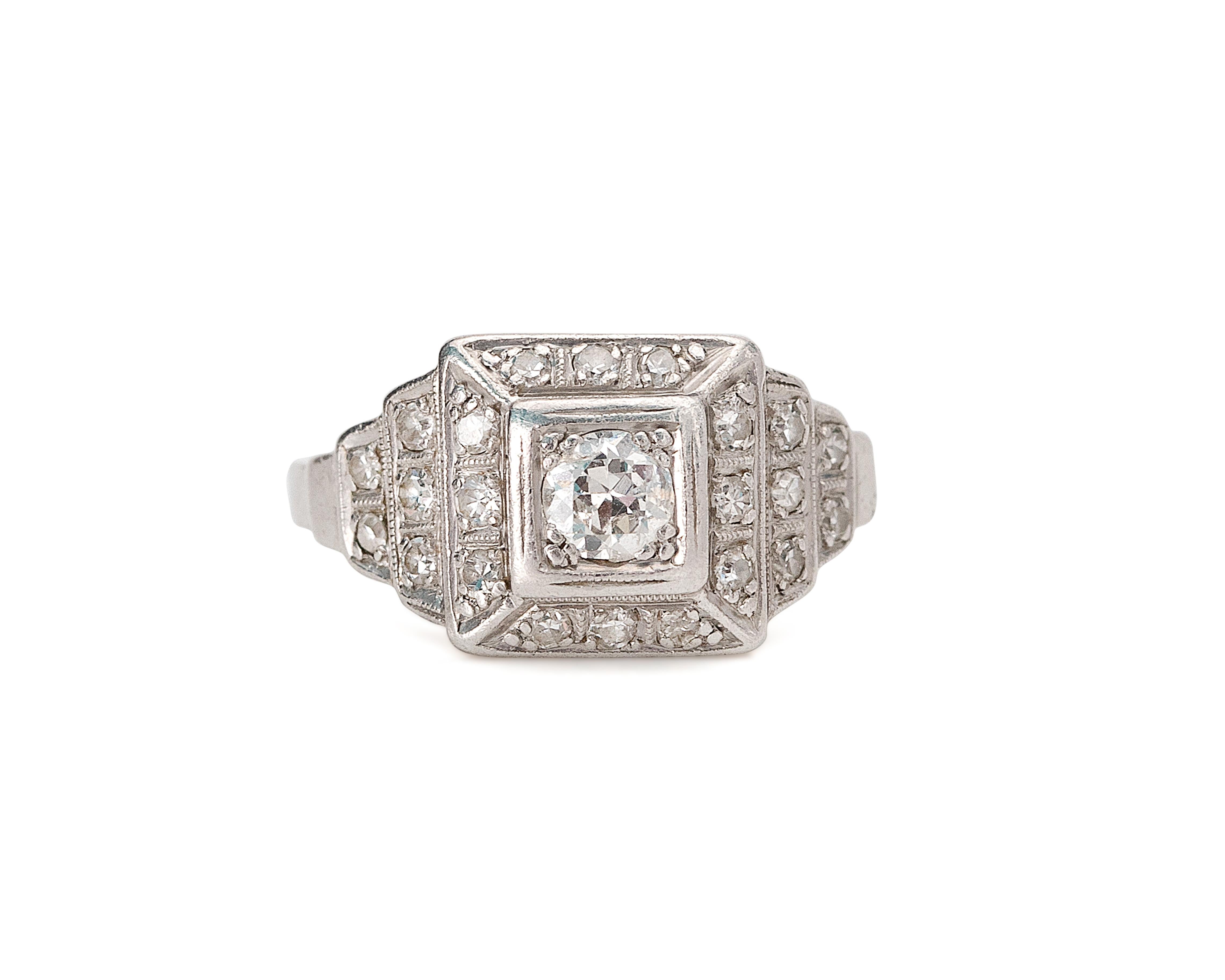 This 1920's beauty is a great example of the geometric elements commonly associated with the Art Deco era. A well defined squared angular halo of antique single cuts accent the  lively 1/4 carat old cut center, the ring then tapers down to two more