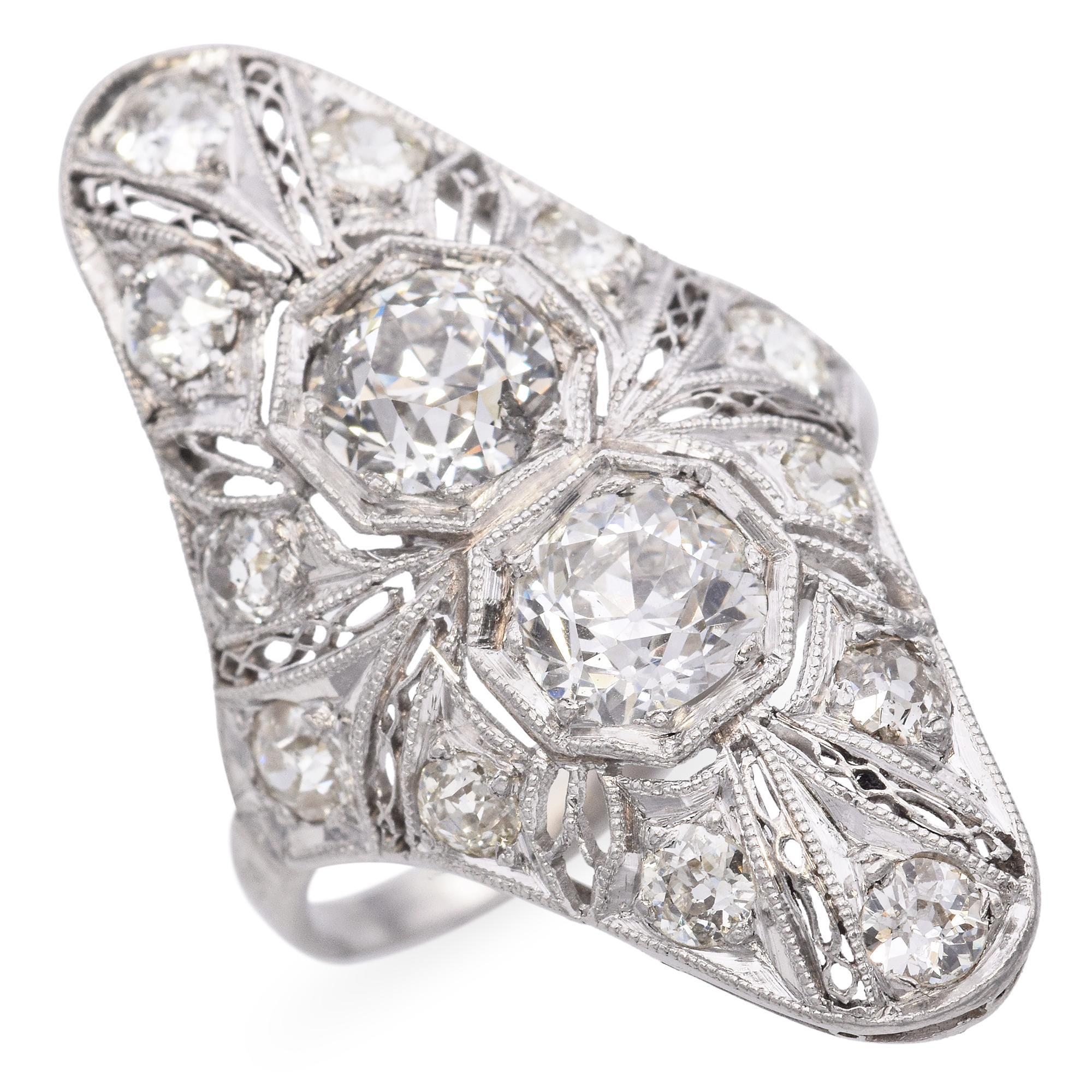 Elegant Antique Ring with Intricate Diamond Design. This exquisite piece features a detailed arrangement of sparkling diamonds set in a sophisticated pattern. The ring showcases two prominent central diamonds surrounded by smaller accent stones, all