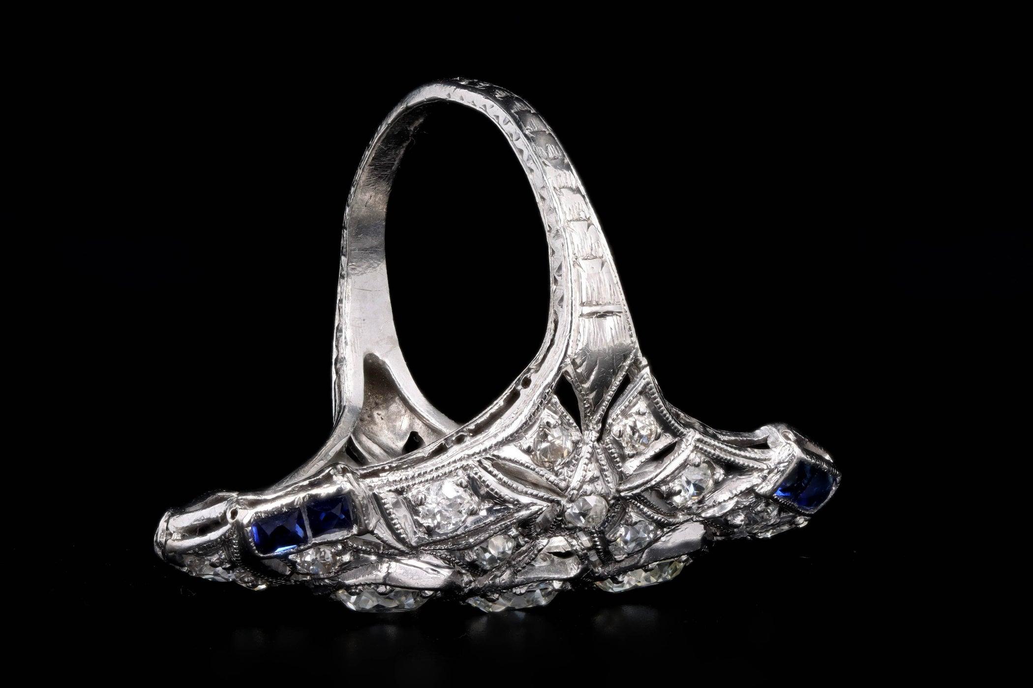 Era: Art Deco

Composition: Platinum

Primary Stone: Twenty Two Old European Cut Diamonds

Carat Weight: Approximately 2.0 Carats in Total

Color/ Clarity: G-K / VS1-SI2

Accent Stone: Eight French Cut Sapphires 

Carat Weight: Approximately 0.50