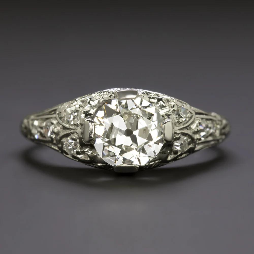 This timeless Art Deco engagement ring showcases a captivating 1.00 carat Old European cut diamond, nestled in an intricately handcrafted platinum setting. The center stone, graded H color and SI2 clarity, faces up beautifully white and is