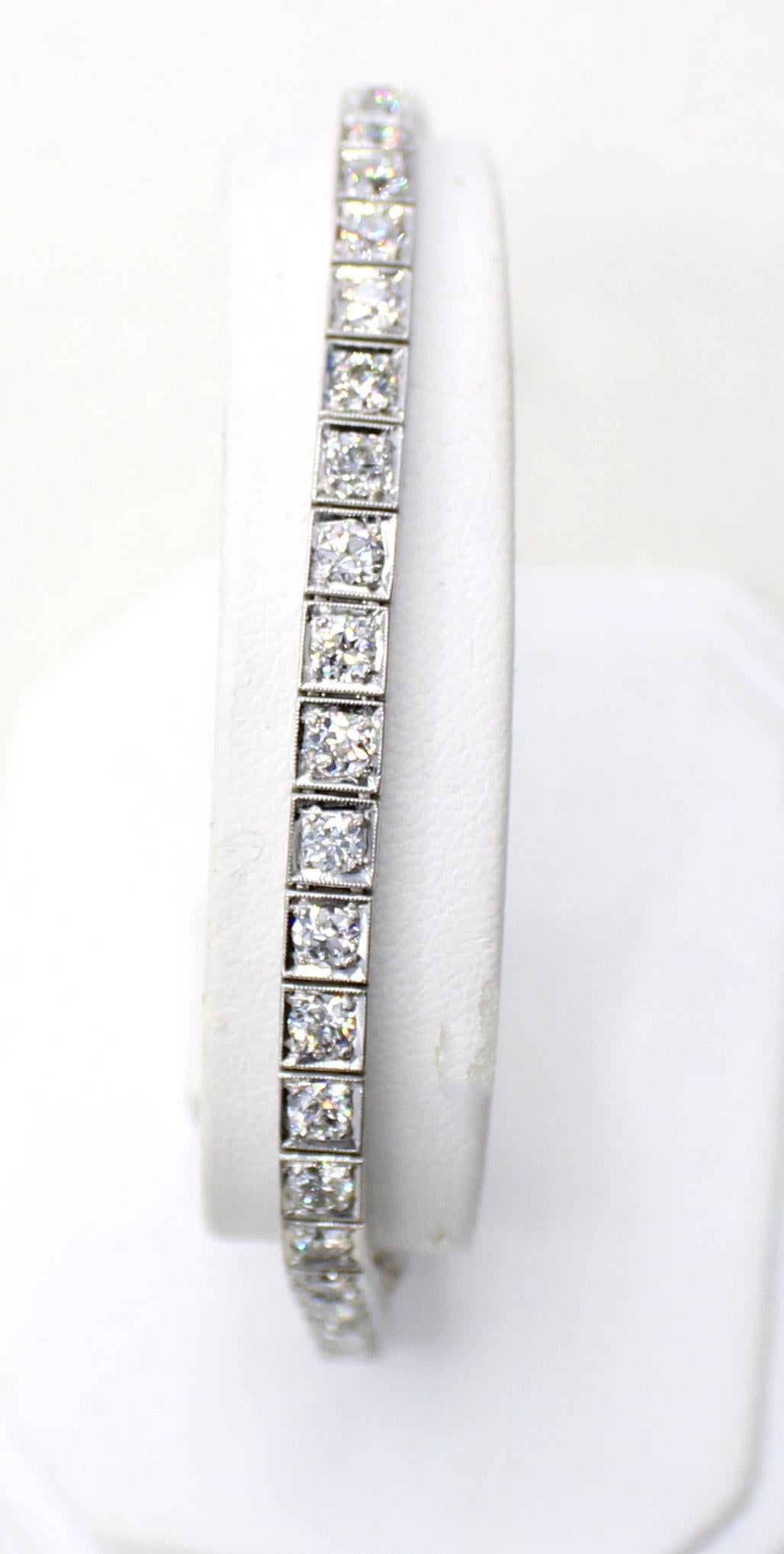 Masterfully handcrafted with beautiful hand-engraving on the sides, this Art Deco platinum bracelet is set with 39 bright white Old European Cut diamonds with an approximate total weight of 5.10 carats. Length 7 inches 