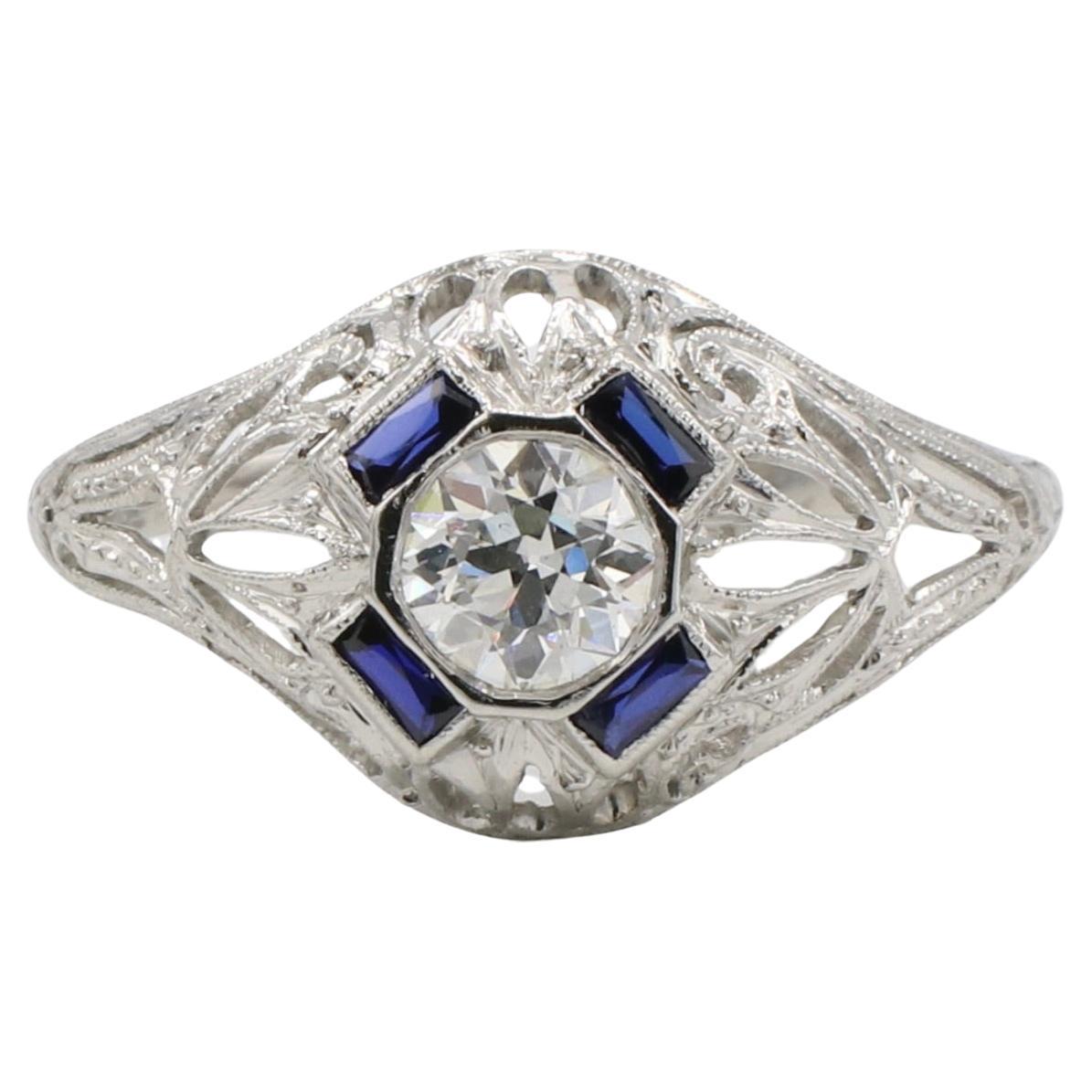 Art Deco Platinum .50 Carat Old European Cut Natural Diamond & Blue Sapphire Dome Ring 
Metal: Platinum
Weight: 4.18 grams
Diamonds: Approx. .50 carat H SI1 Old European Cut natural diamond
Sapphires: Synthetic blue sapphires 
Top: 16.5 x