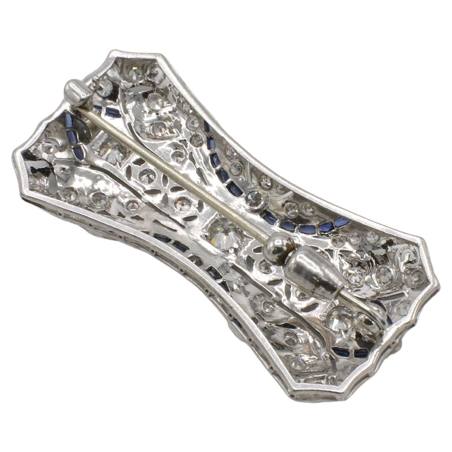 Art Deco Platinum Old European Cut Natural Diamond & Sapphire Brooch Pin
Metal: Platinum
Weight: 11.23 grams
Dimensions: 1.75 x 0.75 inches
Diamonds: Approx. 1.50 CTW H-I VS-SI old European cut natural diamonds 
KDD 111180-1
