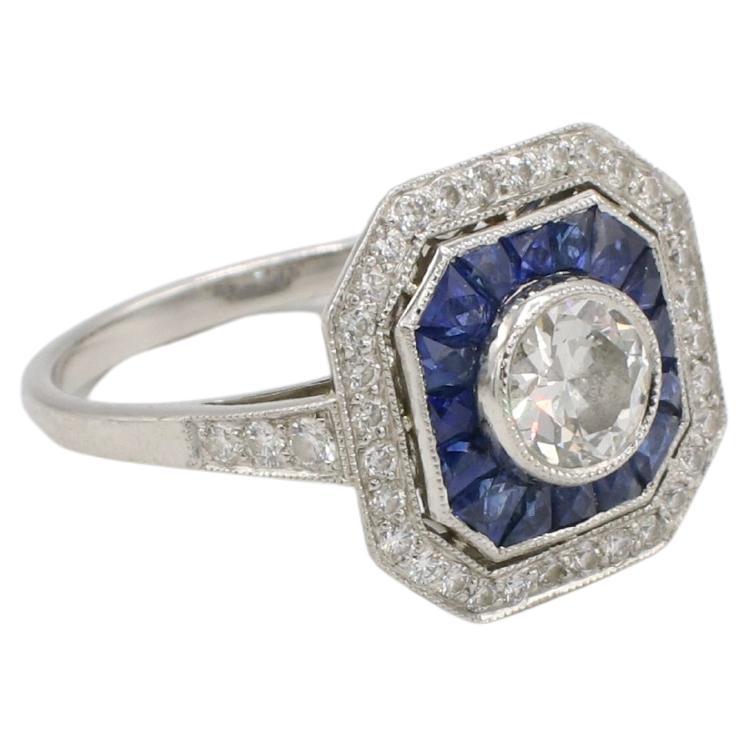 Art Deco Platinum Old European Cut Natural Diamond & Sapphire Cocktail Ring 
Metal: Platinum
Weight: 5.03 grams
Diamonds: Center stone is approx. .60 old European cut I VS2 natural diamond. 
Accent diamonds: Approx. .45 CTW round G-H VS natural