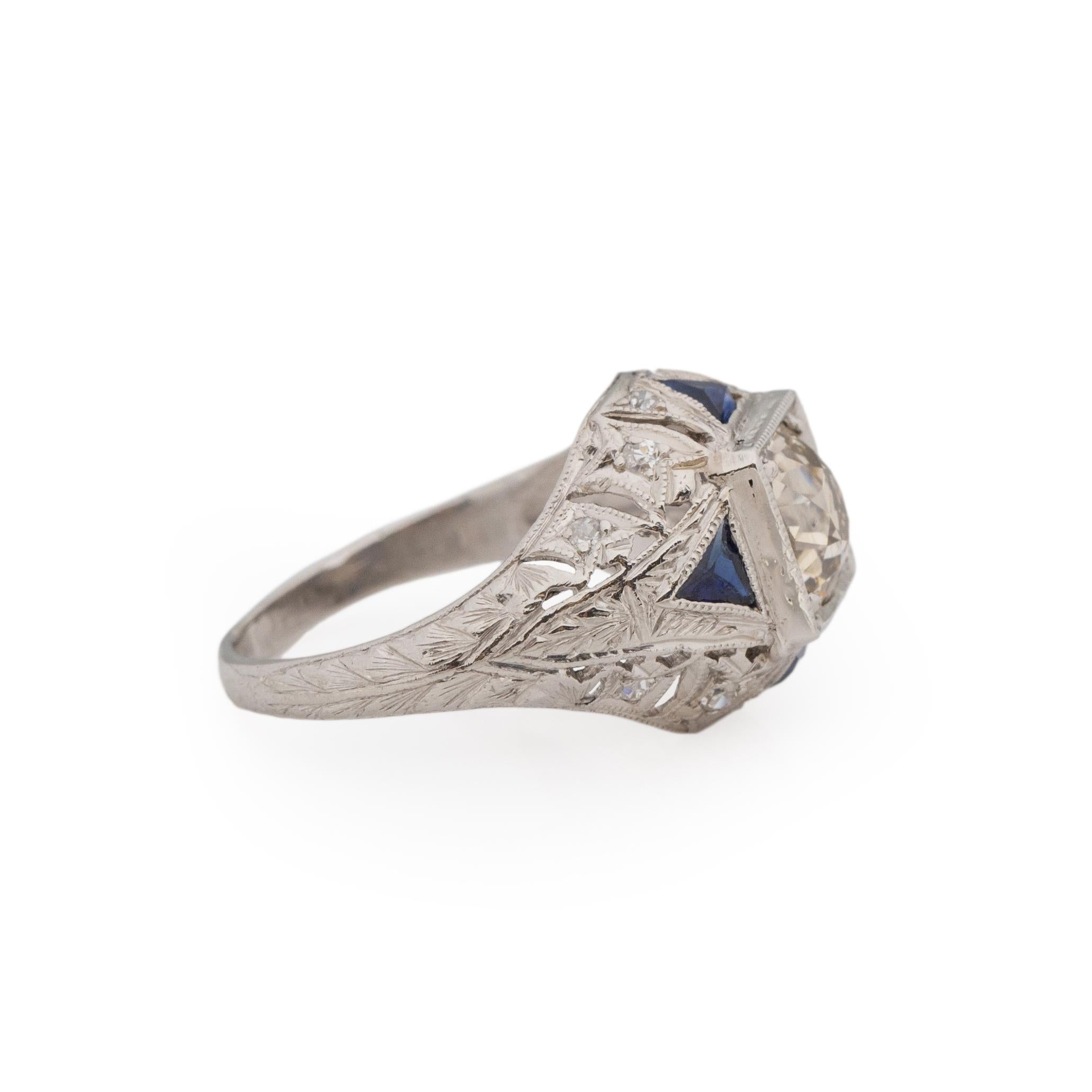 This art deco piece would be perfect for men or woman, engagement ring, offhand ring or just because! Crafted in platinum this stunner has a wider band that showcases delicate floral engraving and bold carved open work. Giving the overall ring a eye