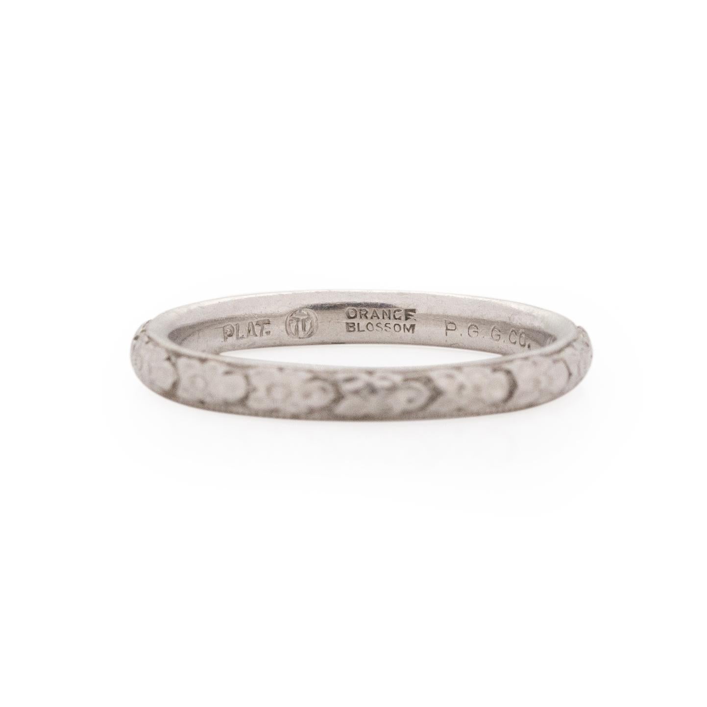 Orange Blossom is a well know vintage band designer, and we are so happy to be able to show case some in our shop. This particular band is crafted in platinum with a beautiful repeating floral pattern that expands all around the ring. This ring