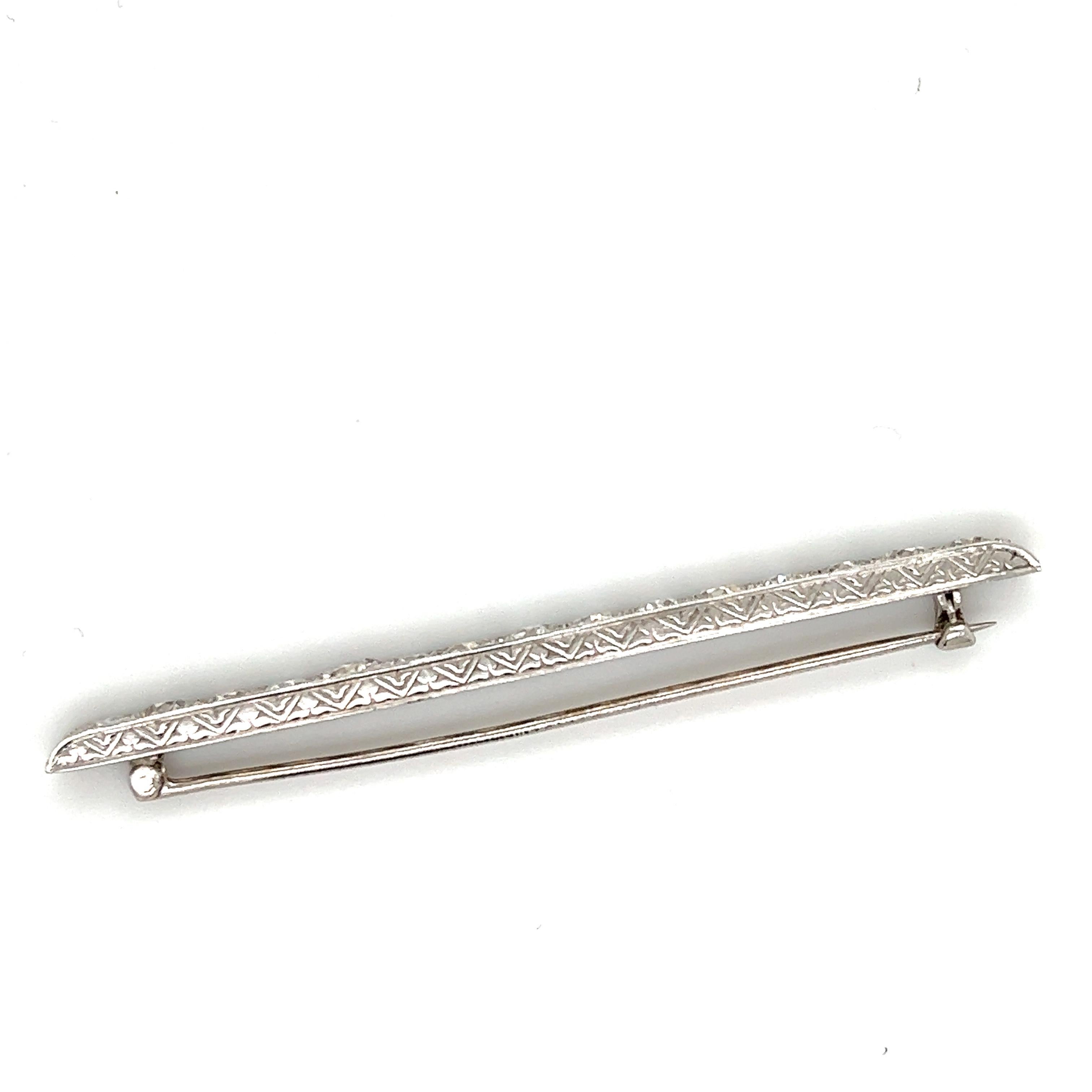 Gorgeous creation from the Art Deco time period. The pin is crafted in platinum with filagree details decorating the piece. The pin shows sharp angles as the pin is set with over 4.50 carats of natural old mine cut diamonds. The diamonds in the