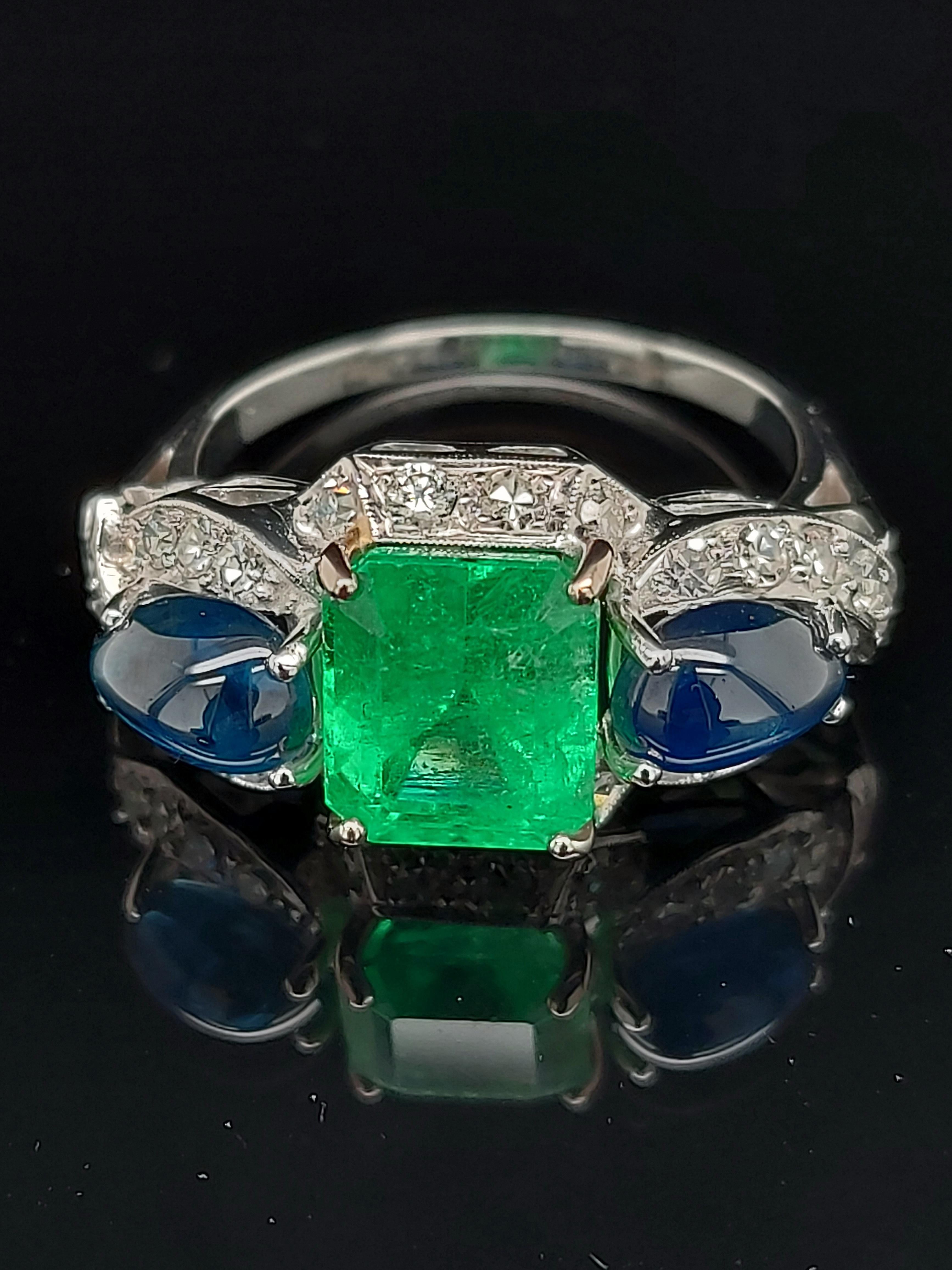 Unique art deco Platinum ring with colombian emerald, cabochon sapphires and diamonds 

Emerald: beautiful Columbian emerald, ca. 2.60 Cts

Sapphire: Cabochon sapphires of exceptional quality, together ca. 2.50 Cts

Diamonds: 26 diamonds 8/8 cut ,