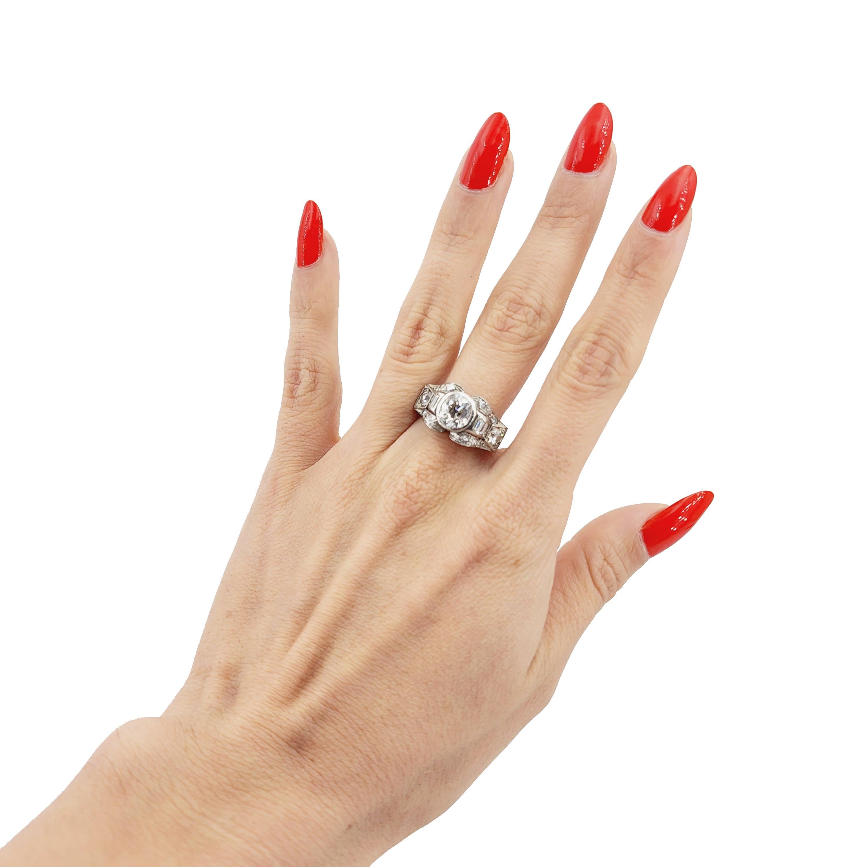 Step into the elegance of the Roaring Twenties with this exquisite Art Deco-era filigree ring, a stunning testament to the craftsmanship and opulence of the period. Crafted in lustrous Platinum, this ring showcases a breathtaking center Old European