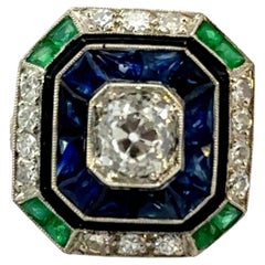 Bague Art Déco en platine avec diamants, saphirs, émeraudes et émail noir