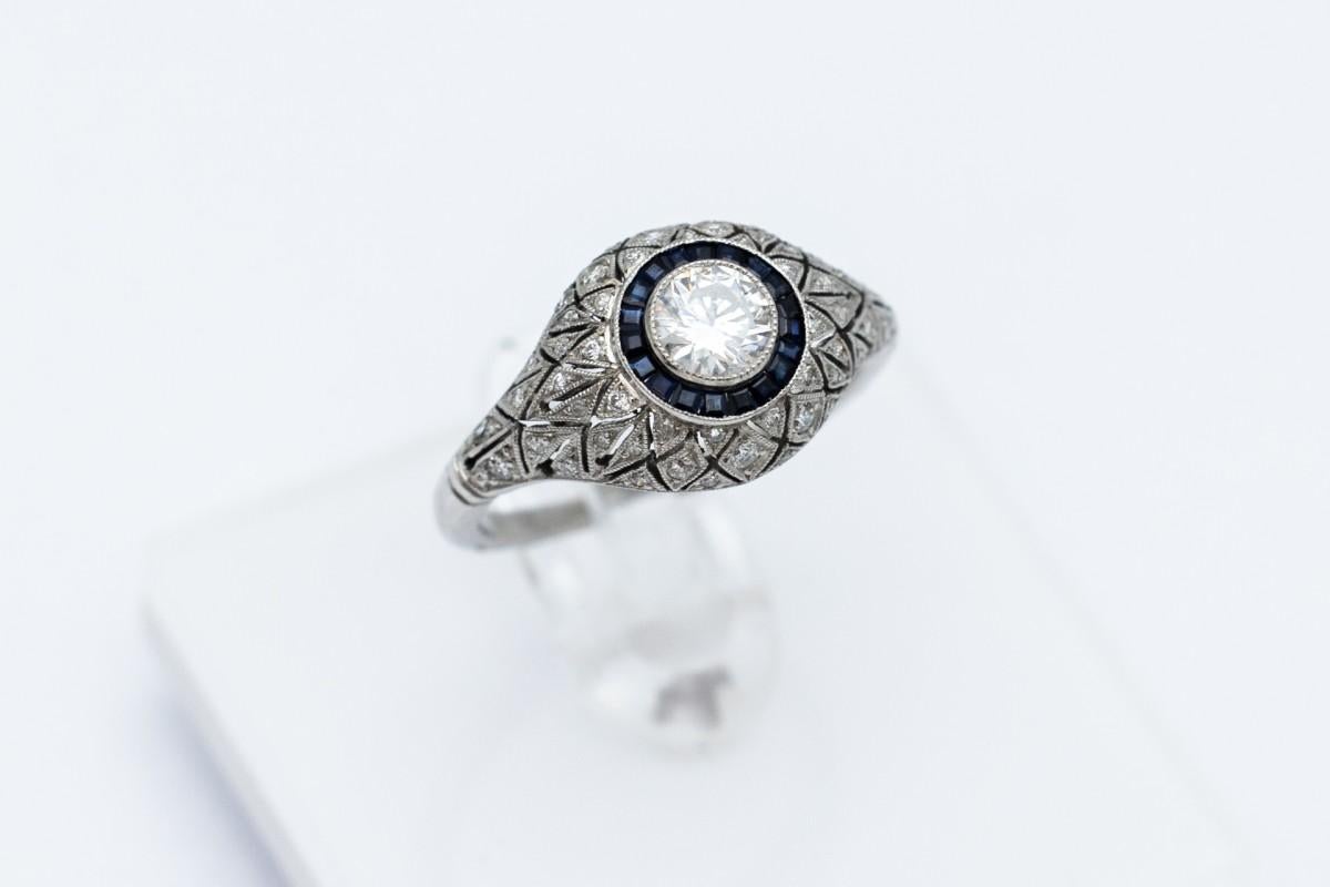 Brilliant Cut Art Deco platinum ring with diamonds and sapphires. For Sale