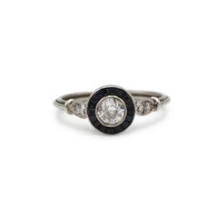 Art Deco Platinum Ring with Old-Cut Diamond and Calibrated Sapphire Halo