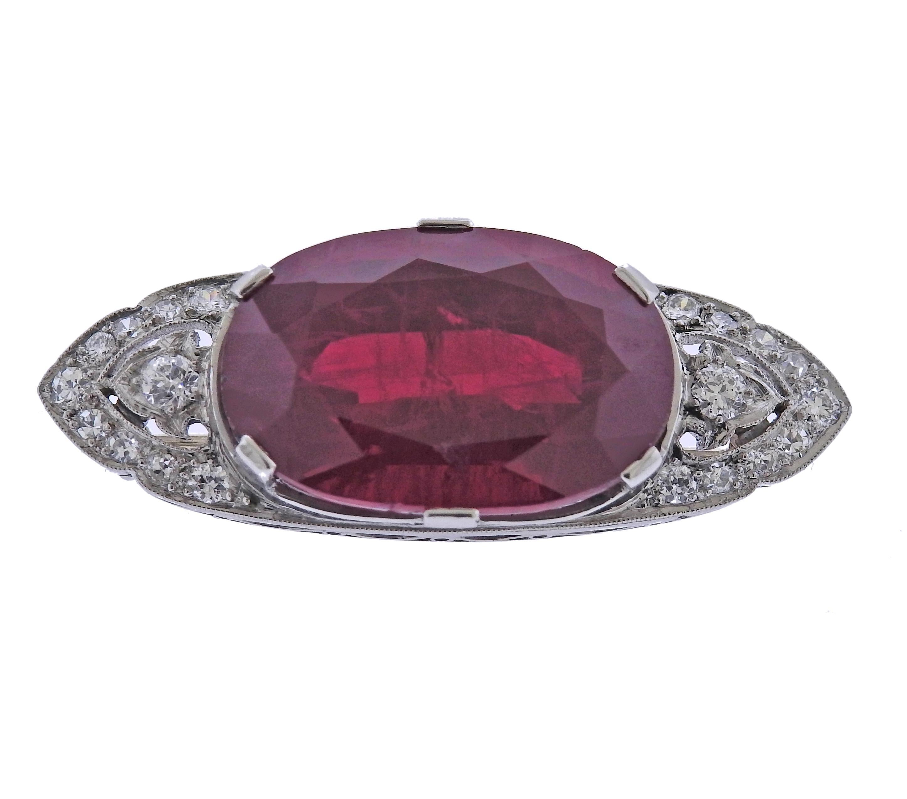 Platinum Art Deco brooch, with center 21.7 x 14.5 x 10.6mm ruby (chipped on the top) and approx. 0.40ctw in diamonds. Brooch measures 38mm x 15mm. Weight - 12.5 grams.