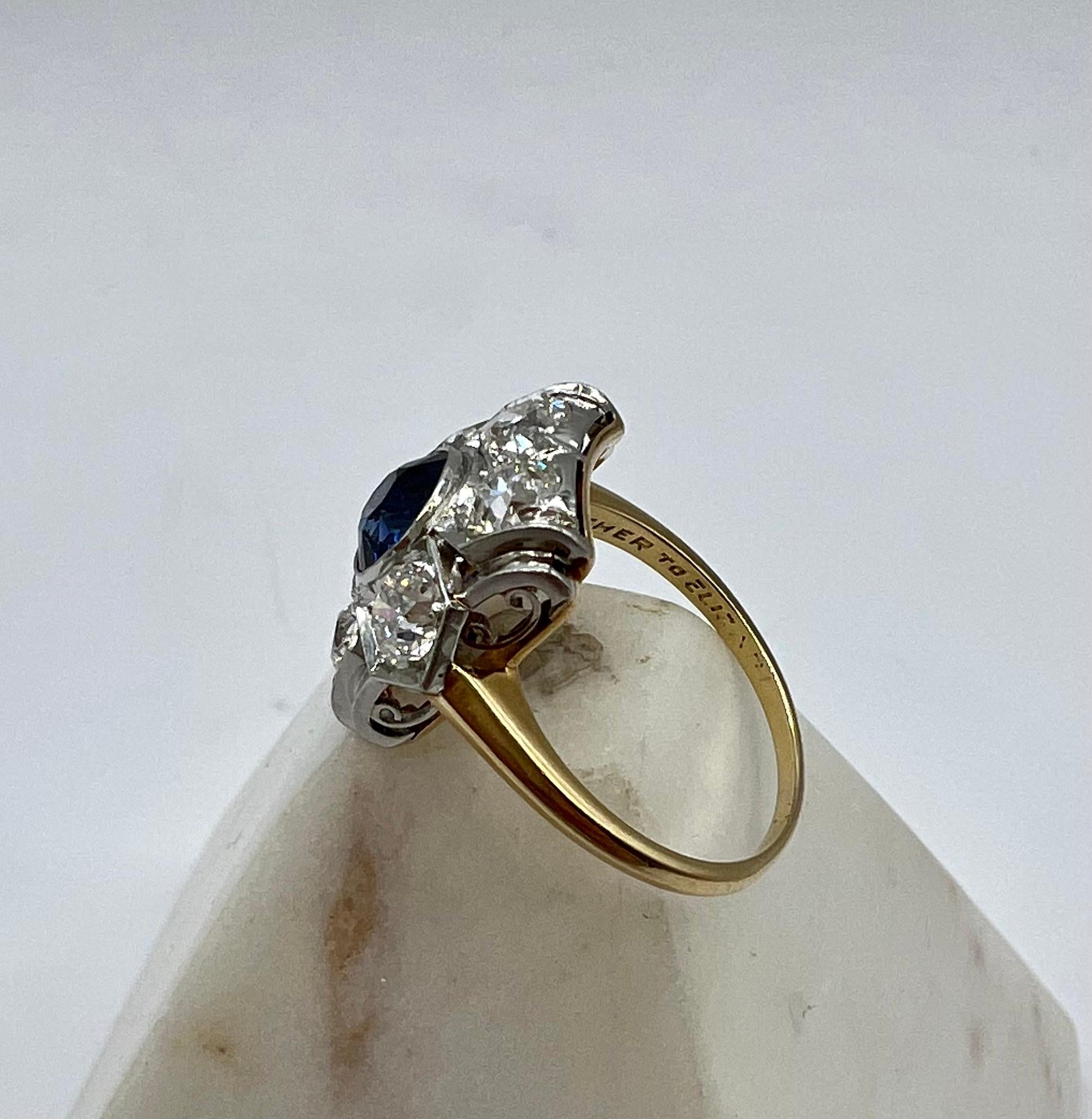 This spectacular diamond and sapphire ring is a stunner. With 2 carats of bright white diamonds surrounded by a 1.05 carat deep blue sapphire set in platinum. The band is 14 karat yellow gold. The ring is 7 1/4 and can be sized.