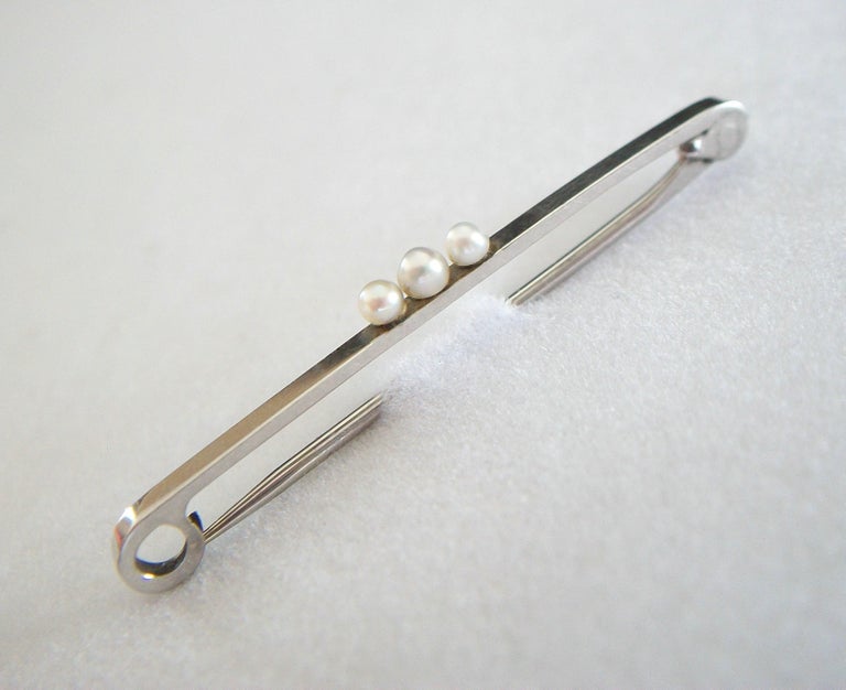 Art Deco Platinum safety pin brooch - featuring three seed pearls to the top - completely hand made - fine quality workmanship with classic details and a warm aged patina - platinum acid tested - signed to the back (see photo) - old auction house