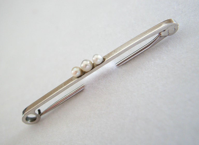 Round Cut Art Deco Platinum & Seed Pearl Safety Pin Brooch - United States - Circa 1925 For Sale