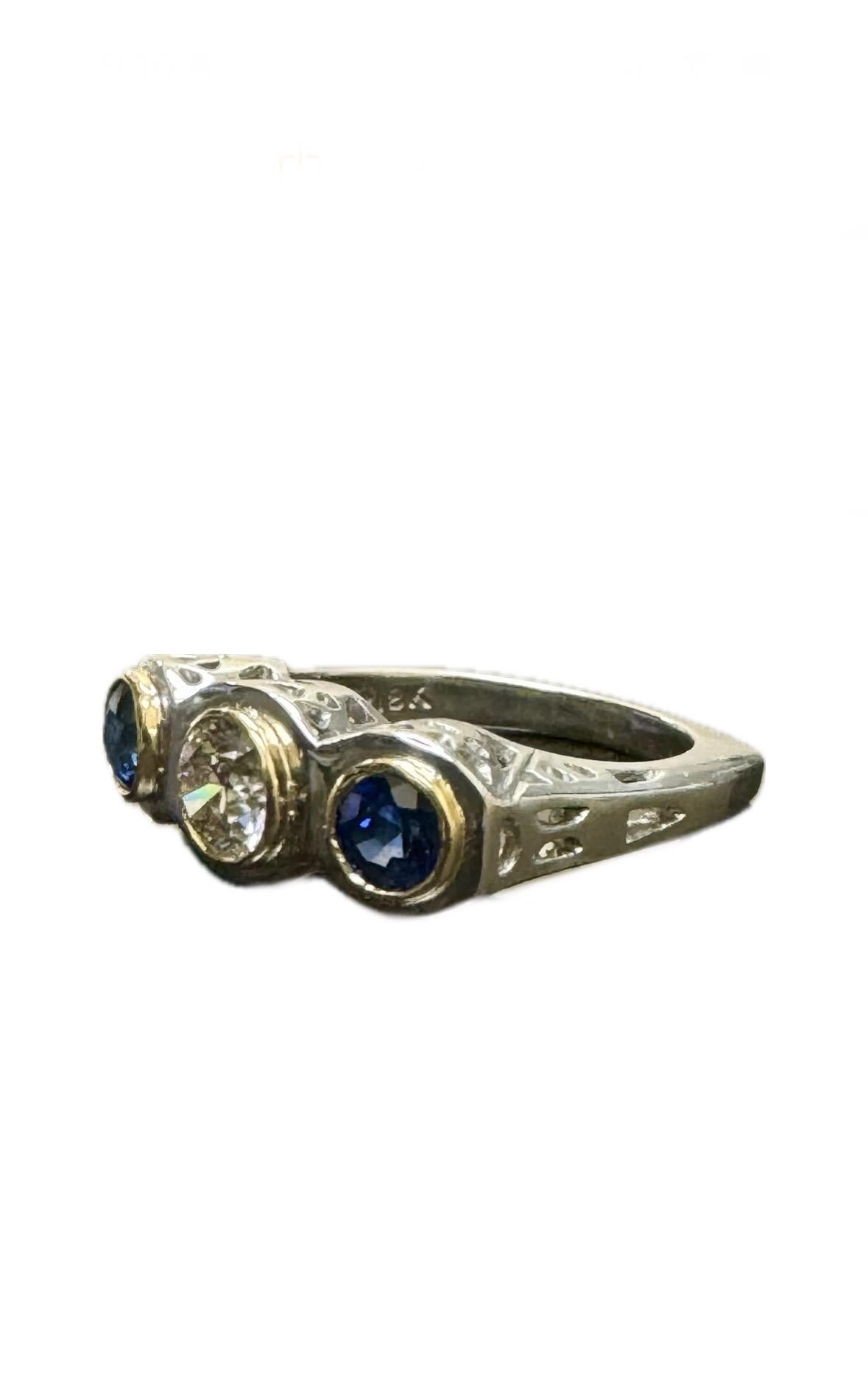 DeKara Designs Collection

Beautiful Modern/Art Deco Ceylon Blue Sapphire and Diamond Ring.

Metal- 90% Platinum, 10% Iridium/18K Yellow Gold, .750.

Stones- Genuine Earth Mined Diamond J-K Color VS1-VS2 Clarity, 2 Round Blue Sapphires 0.82 Carats.