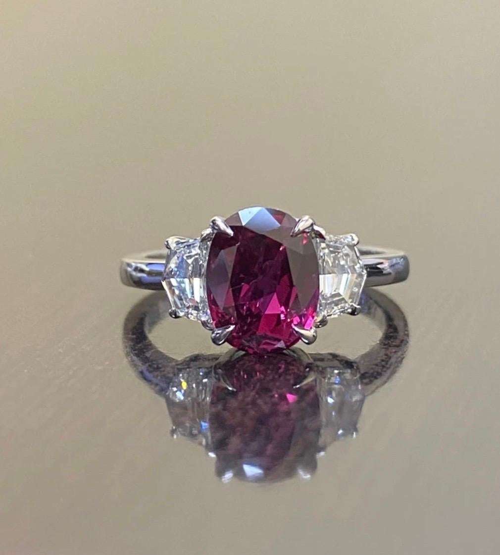 DeKara Designs Collection

Classic/Modern Three Stone Diamond Past Present and Future Engagement Ring.

Metal- 90% Platinum, 10% Iridium

Stones- GIA Certified Oval Ruby 2.34 Carats, Two Special Cut Cadillac Diamonds F-G Color VS1 Clarity, 0.68