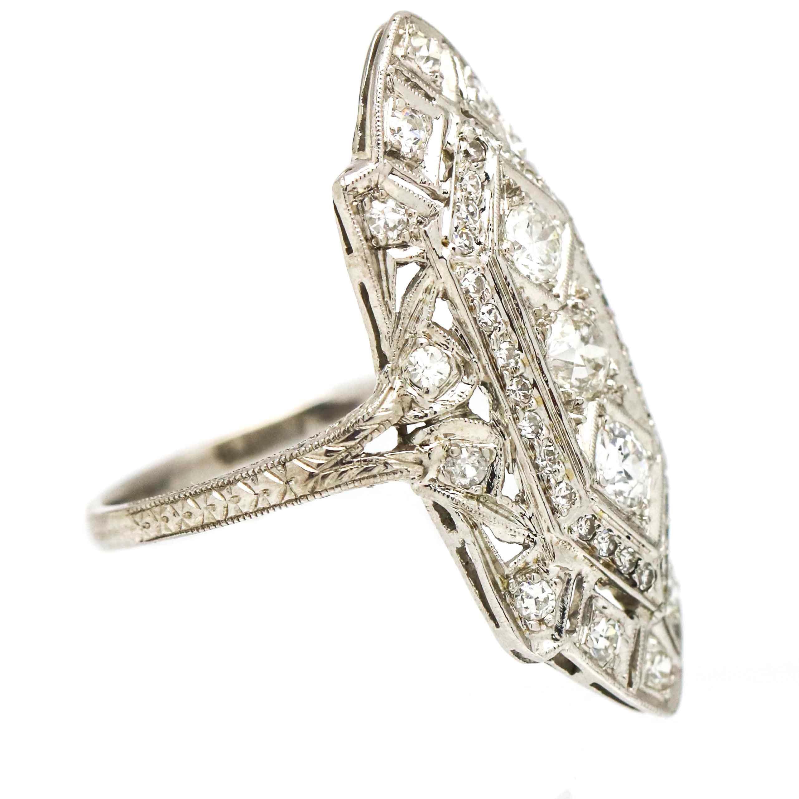 Vintage platinum cocktail ring crafted in platinum. The ring features 3 old european cut diamonds at center with prong set single cut diamonds throughout. Traditional filigree and openwork details on setting. VS-SI, H-I.
