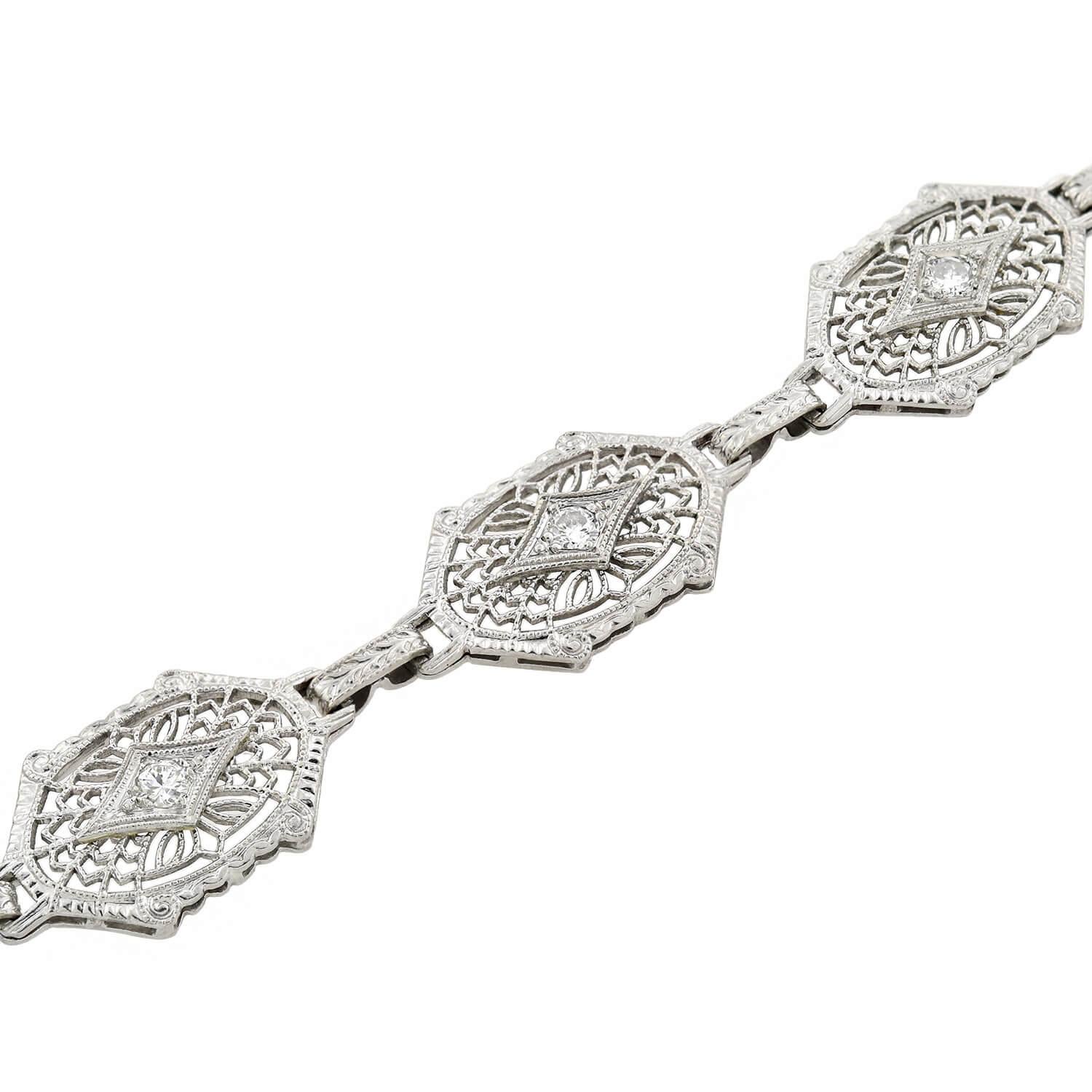 A stunning filigree bracelet from the Art Deco (ca1920s) era! Crafted in platinum topped 14kt white gold, this wonderful piece is comprised of eight detailed links that display a fine filigree wirework design. The links connect together at an