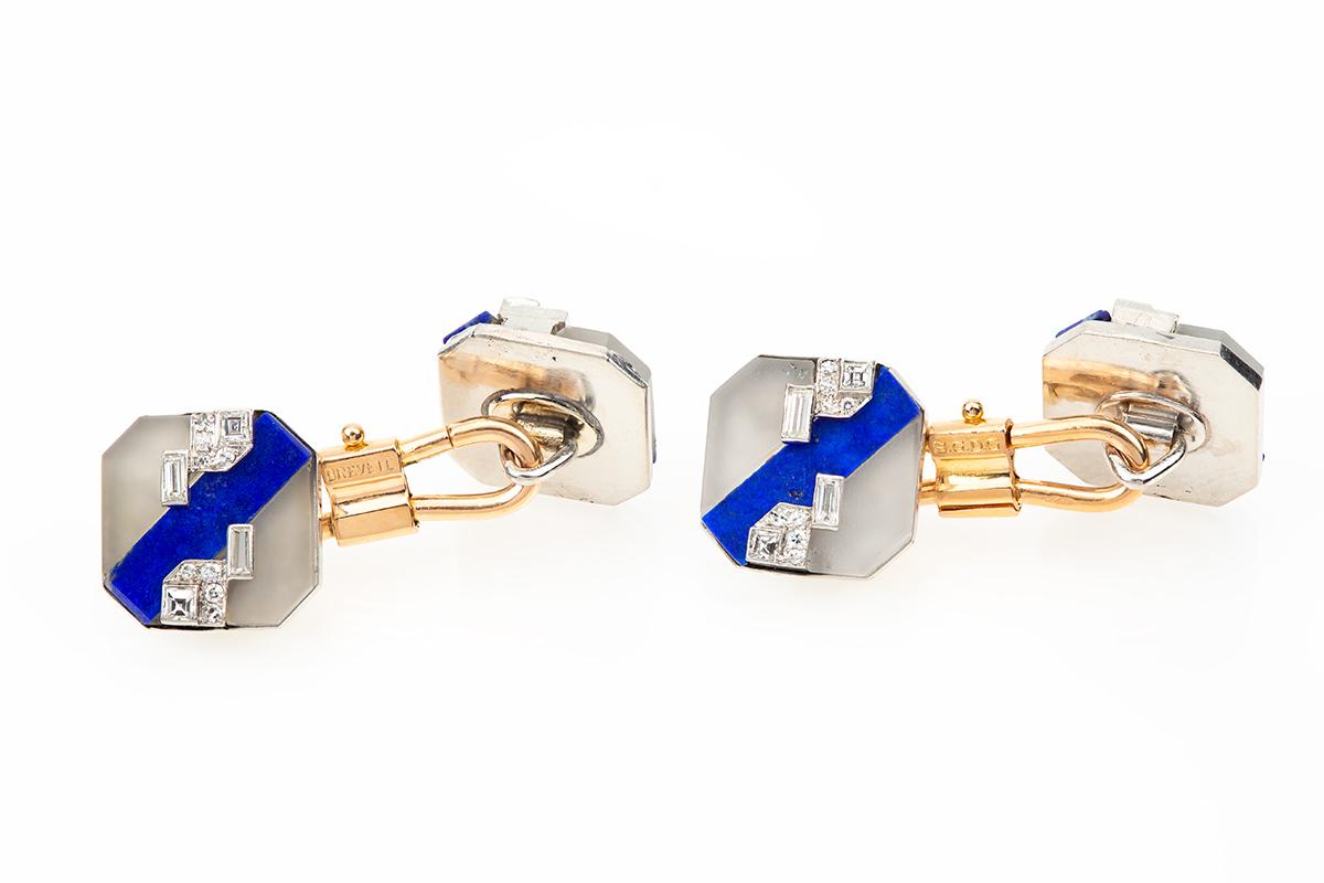 A fine quality pair of platinum mounted,Art Deco period cufflinks set with natural coloured lapis lazuli, frosted crystal,and baguette cut, brilliant and square cut diamonds.measures 13 mm across and with the eagles head stamp denoting French