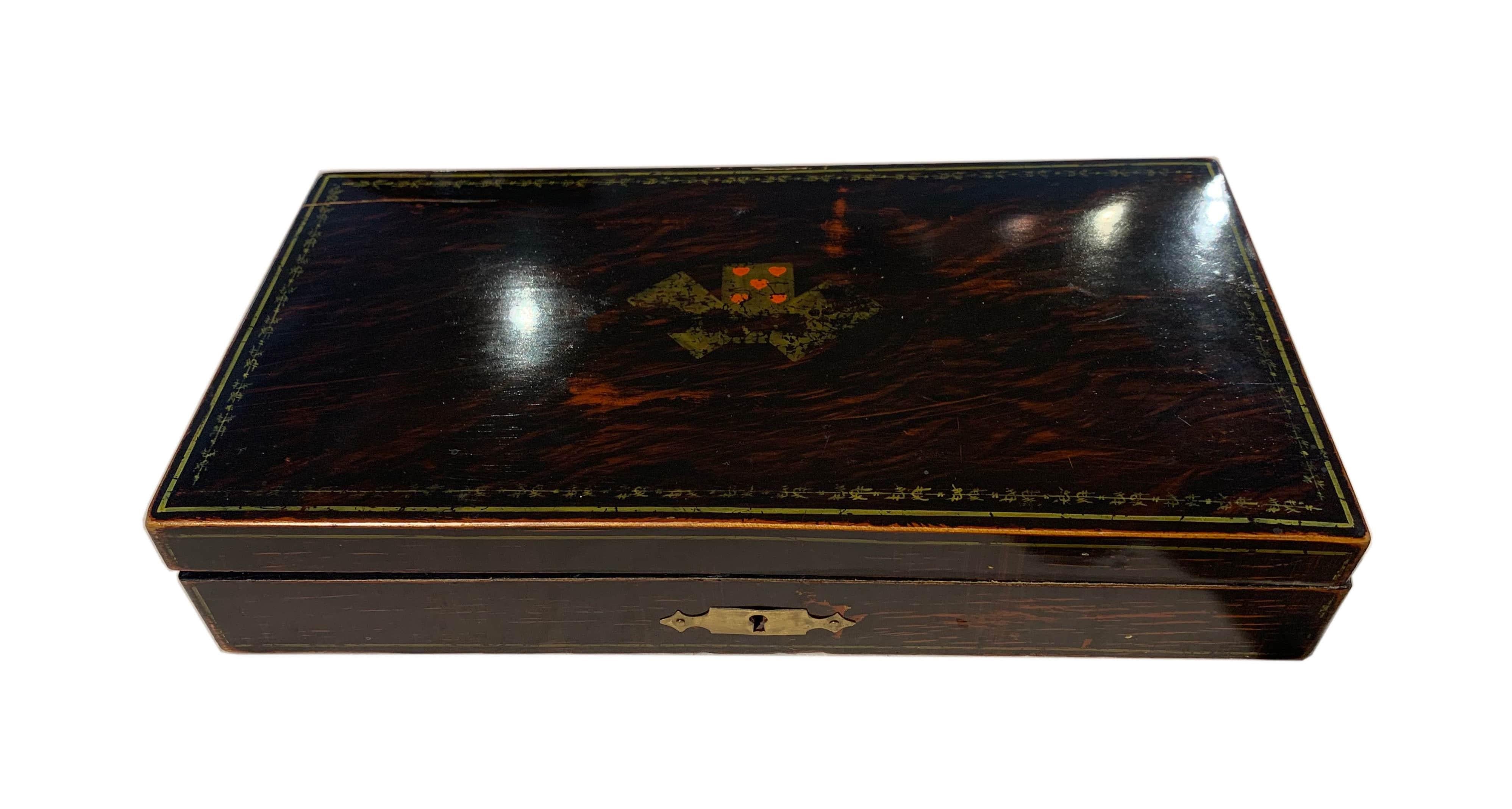 Beautiful Art Deco playing cards casket / box. 

The wood is palisander/rosewood in- and outside and it has a slightly torn down original painted motif of three playing cards on the upper side. 
Around the top cover, there is a are fully painted